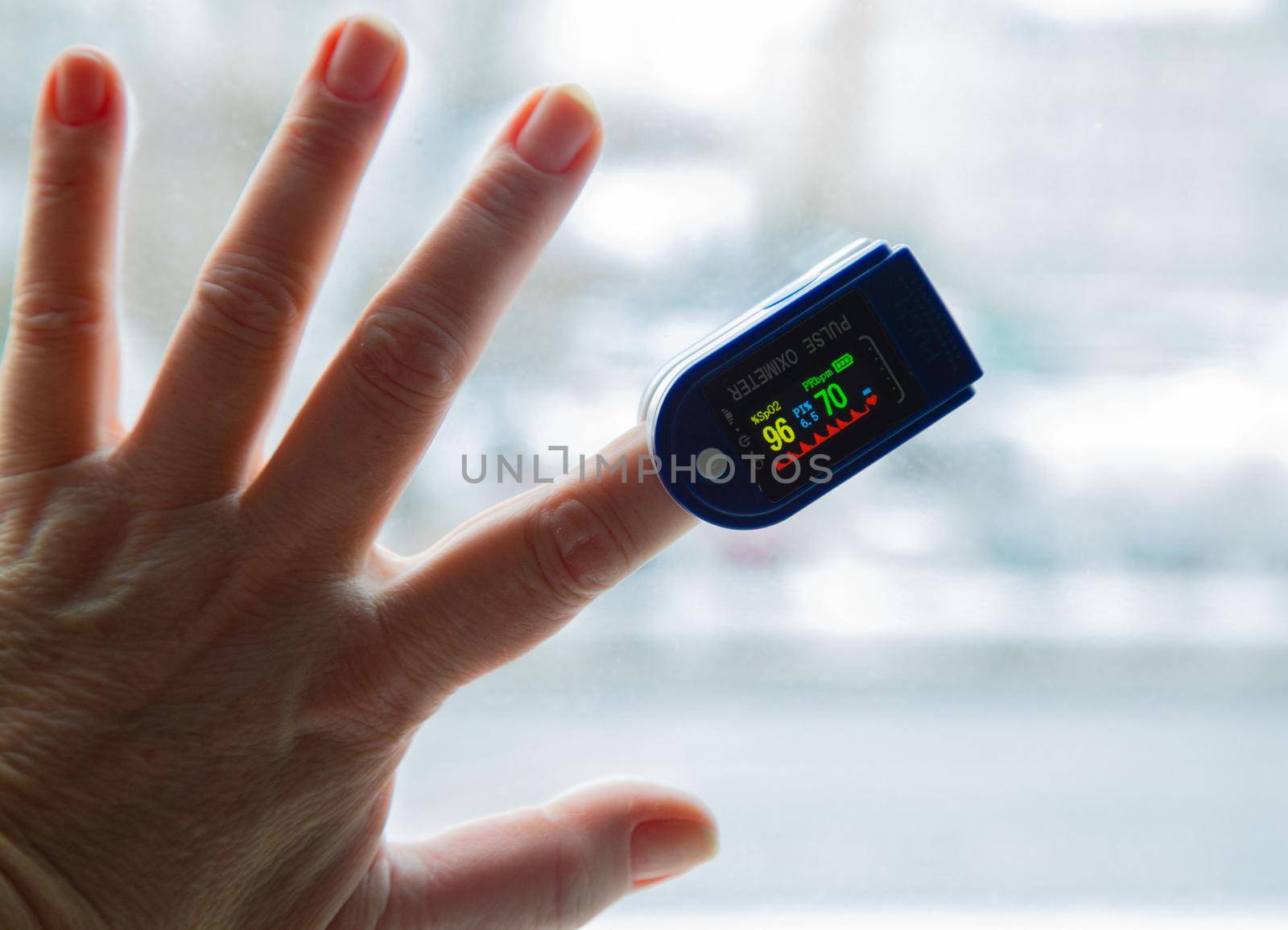 pulsoxymeter on the finger of the hand by L86