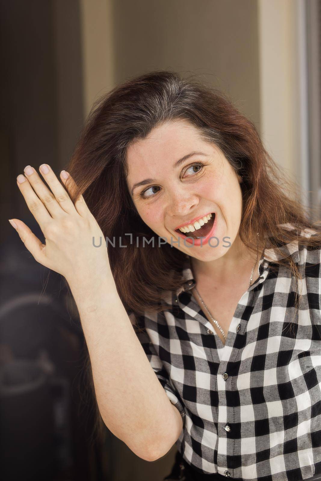 Young woman shows her gray hair roots