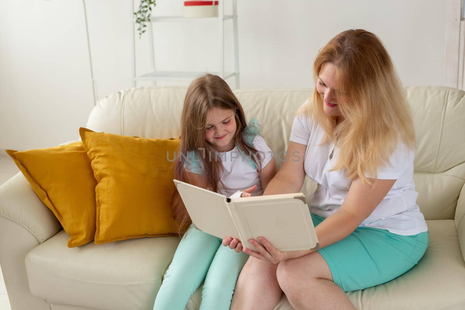 Child with broken arm and gypsum spend time at home with mother. Childhood illnesses, a positive outlook and recovery. by Satura86