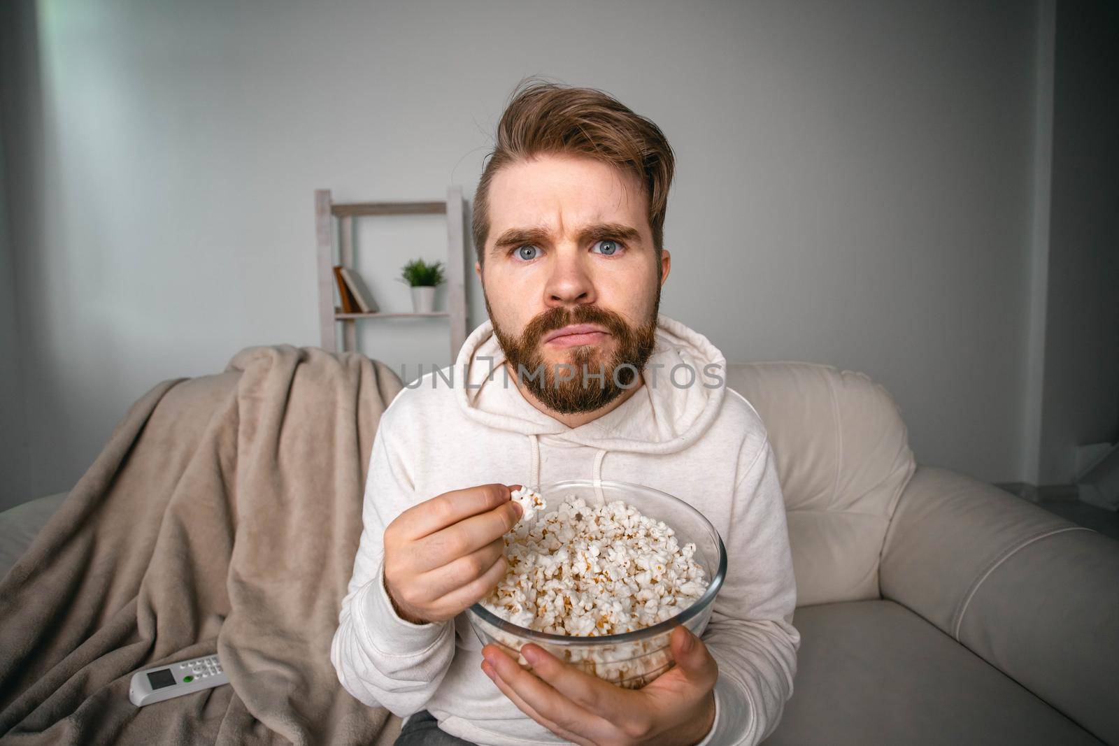 Man watching movies lying on a couch at home
