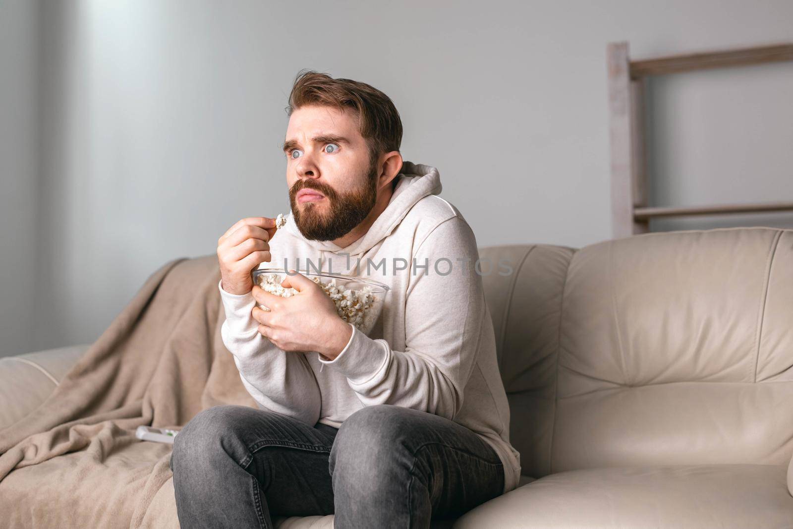 Portrait of guy watching TV series online. Online cinema and video streaming service