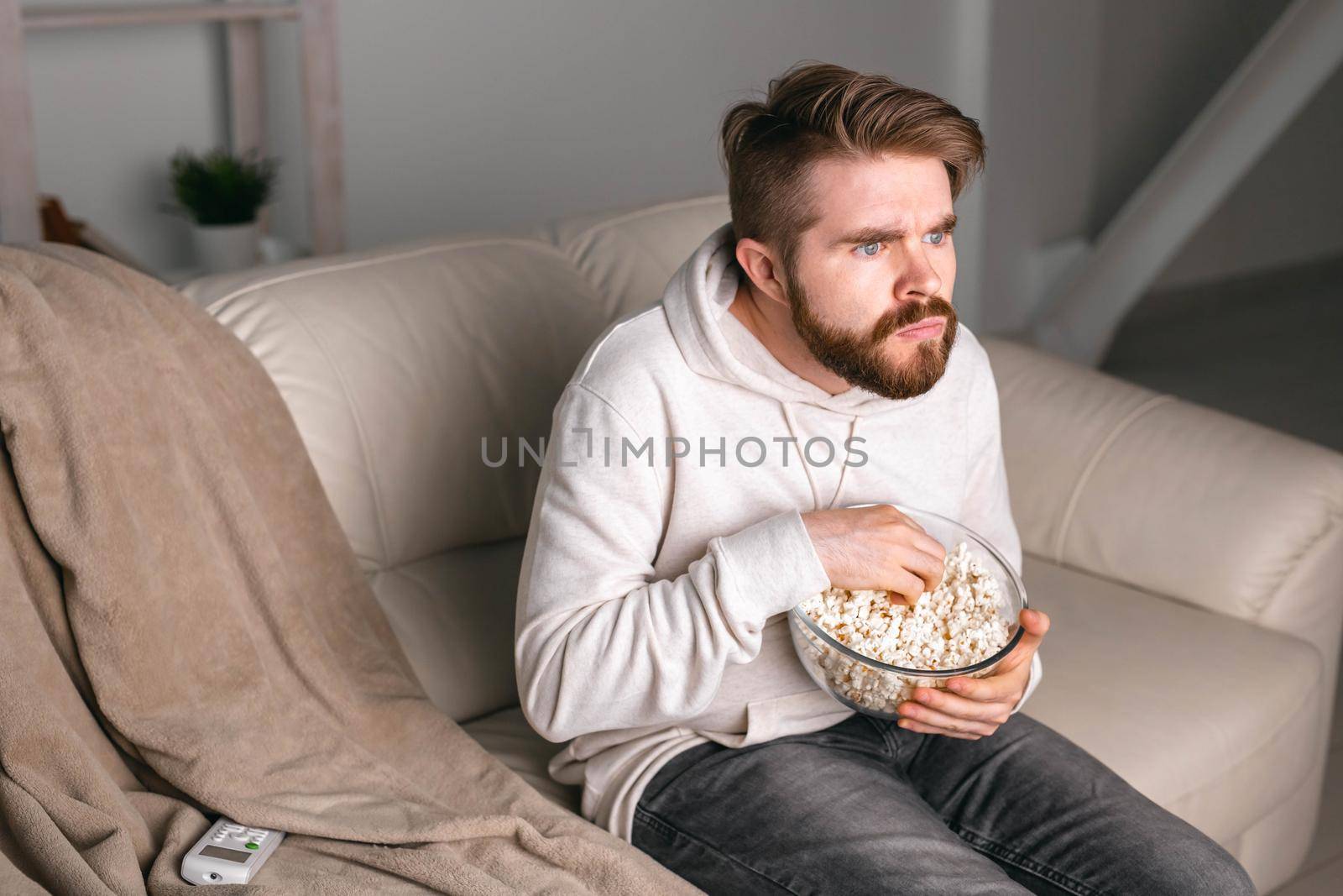 Portrait of guy watching TV series online. Online cinema and video streaming service