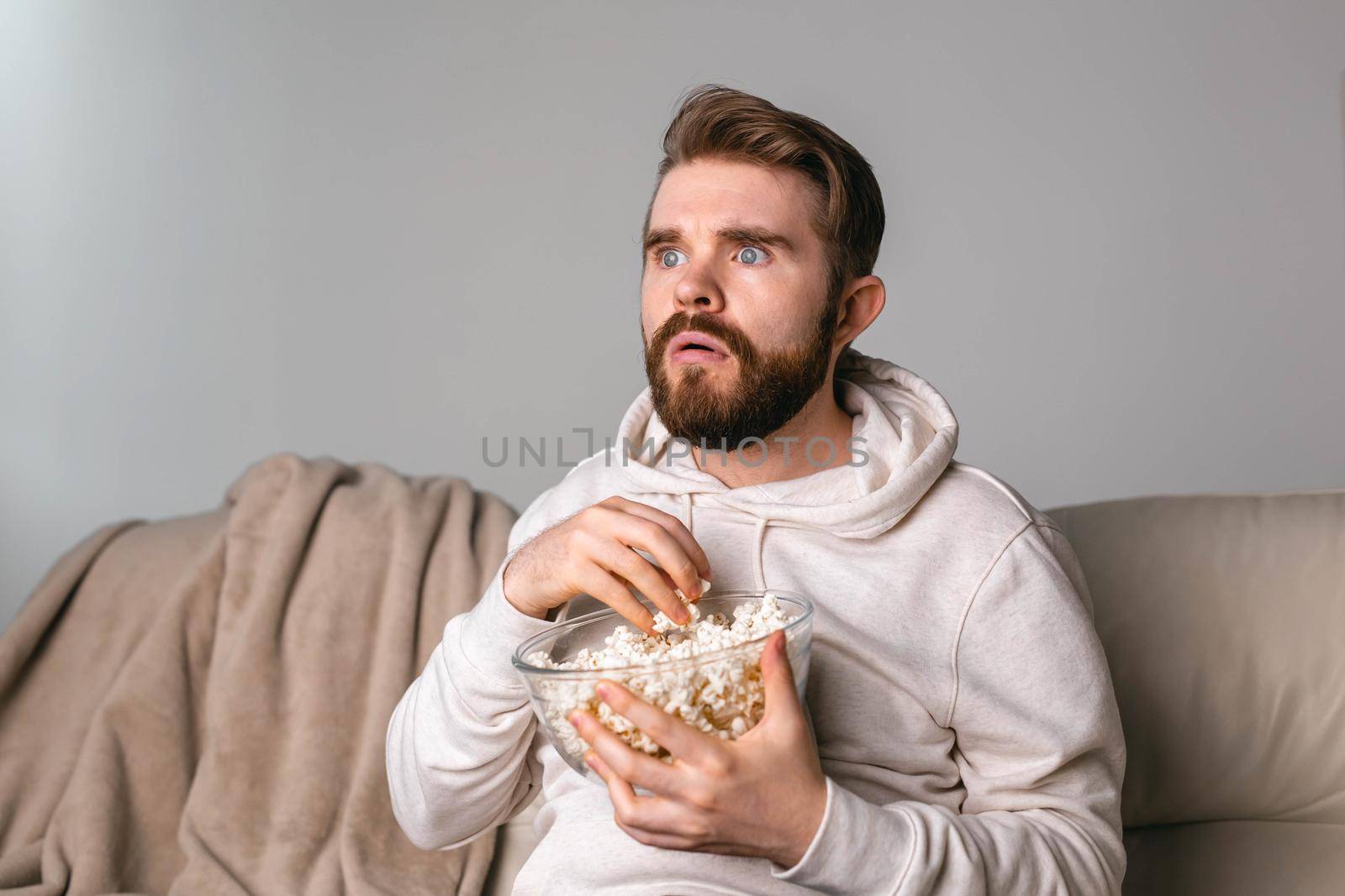 Portrait of guy watching TV series online. Online cinema and video streaming service