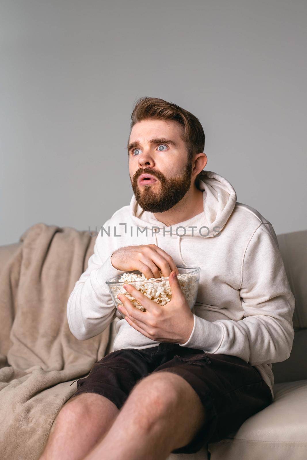 Portrait of guy watching TV series online. Online cinema and video streaming service