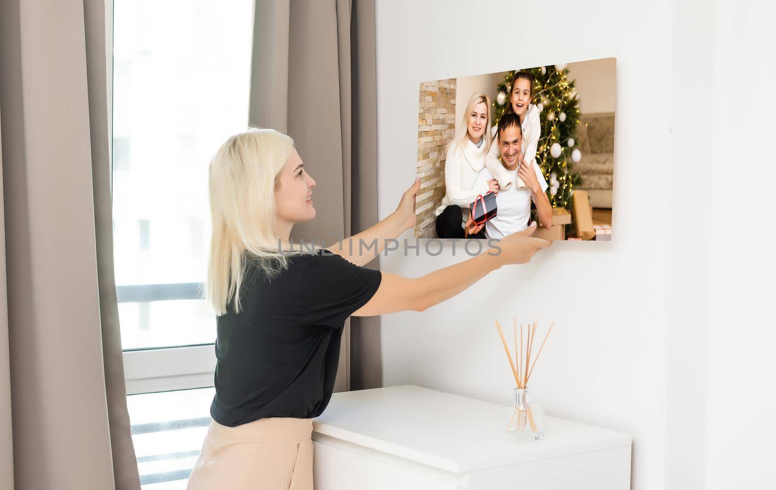 woman holding a photography with gallery stretch on a wooden frame. Printed photo on canvas.