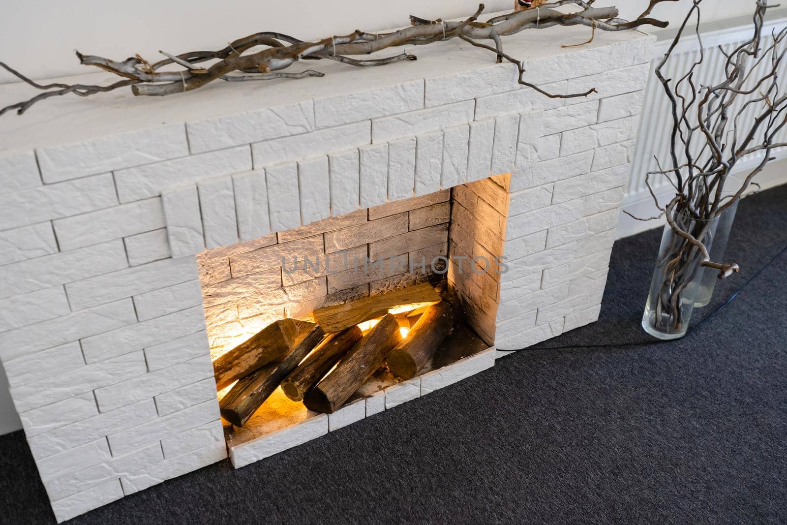 Decorative fireplace on the wall - modern interior. With a white brick