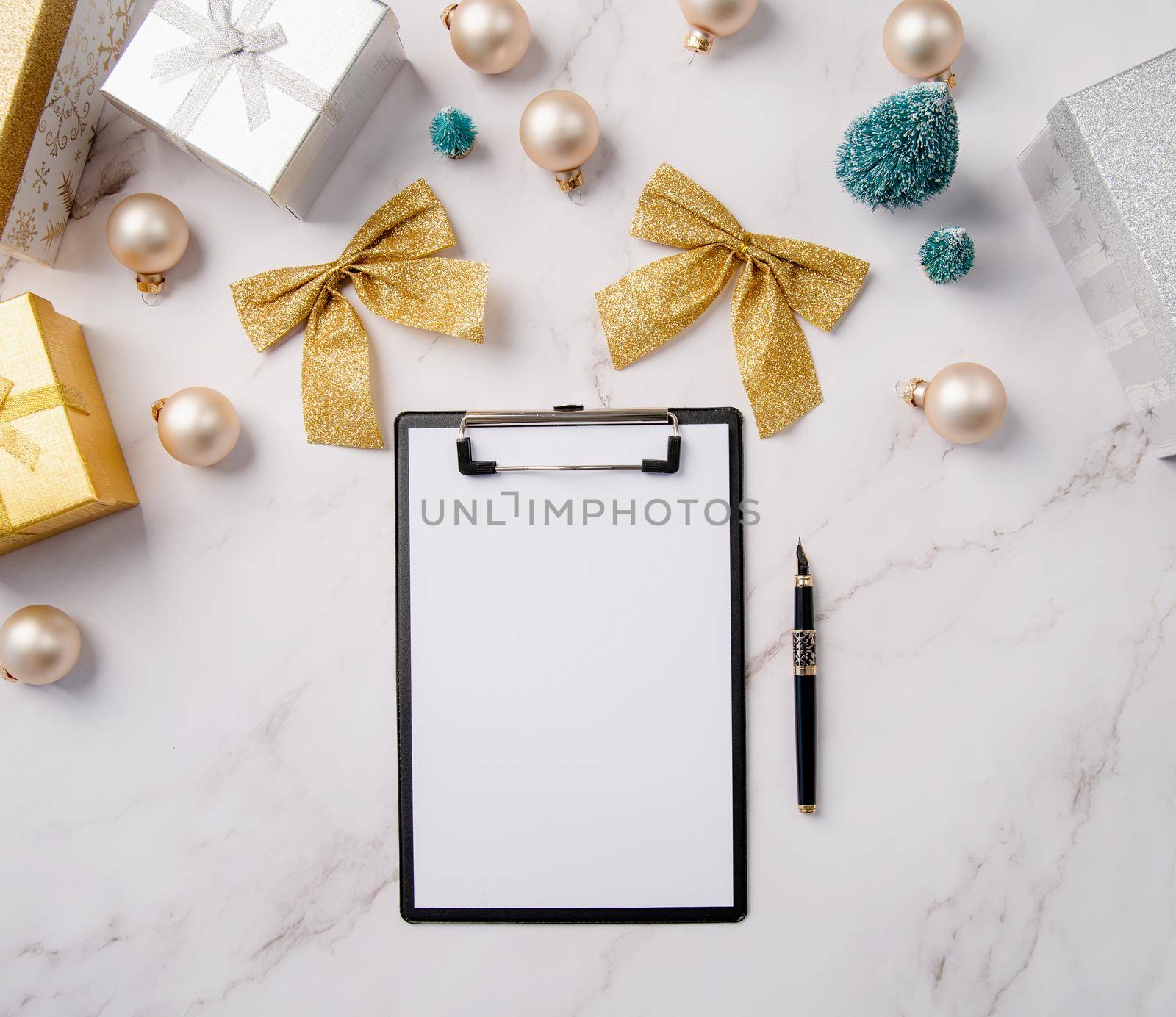 New Year Resolution and Motivation Concept. top view writing new year goals, resolution or shopping list on a blank paper. Mock up design