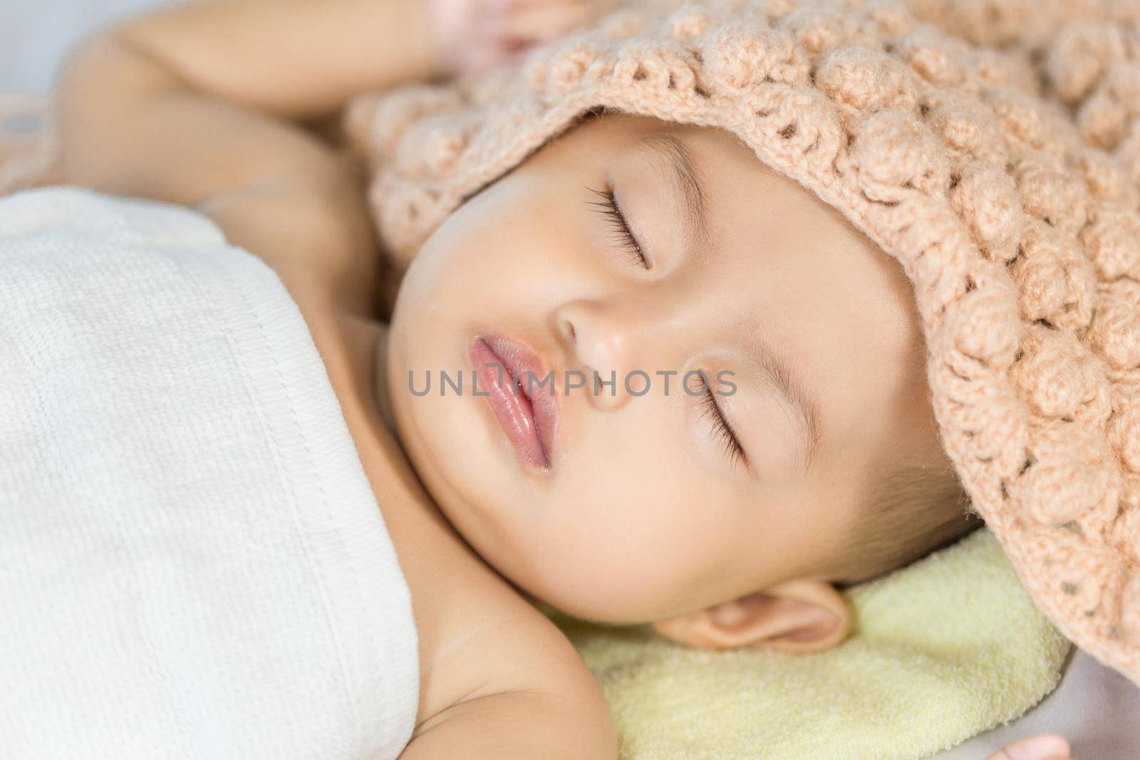 Baby sleeping on bed in the bedroom at home