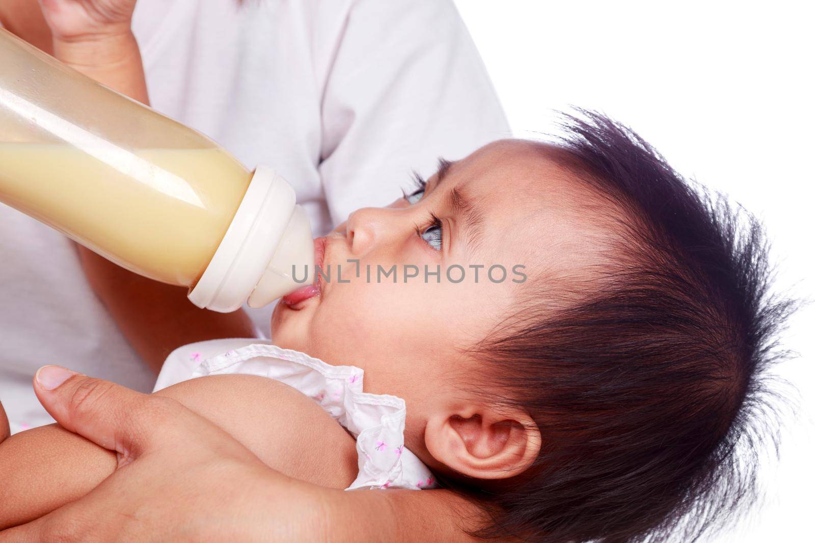 Mother feeding baby daughter isolated on a white background