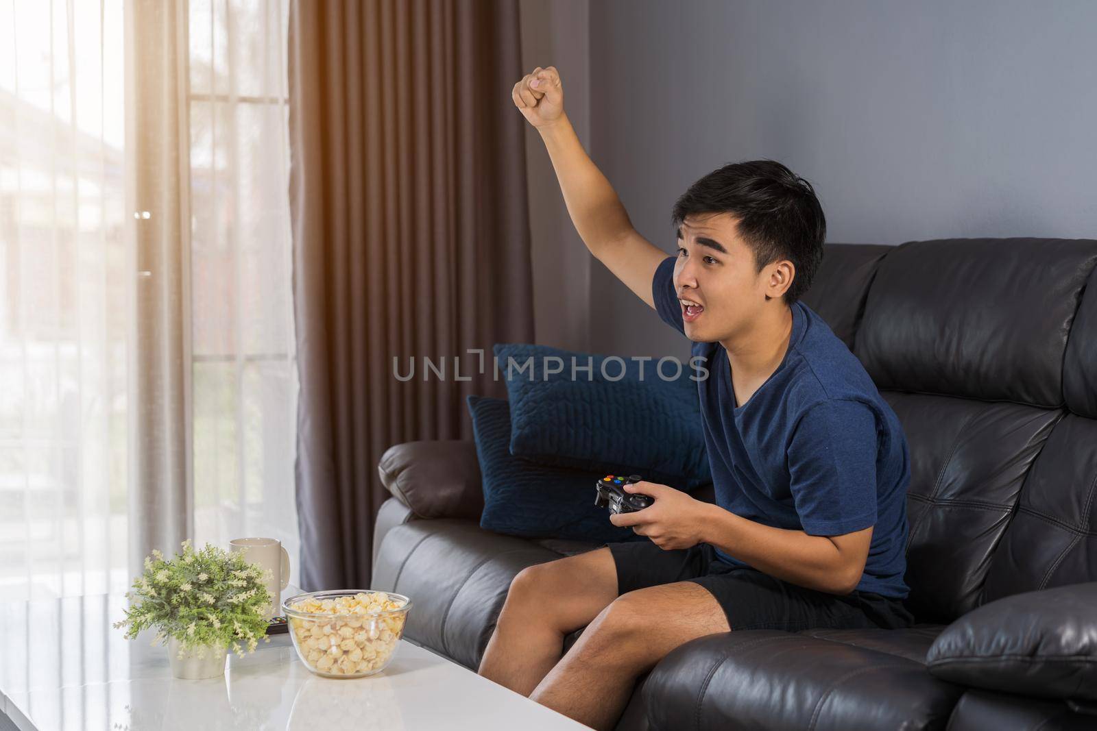 young man playing video games and wins