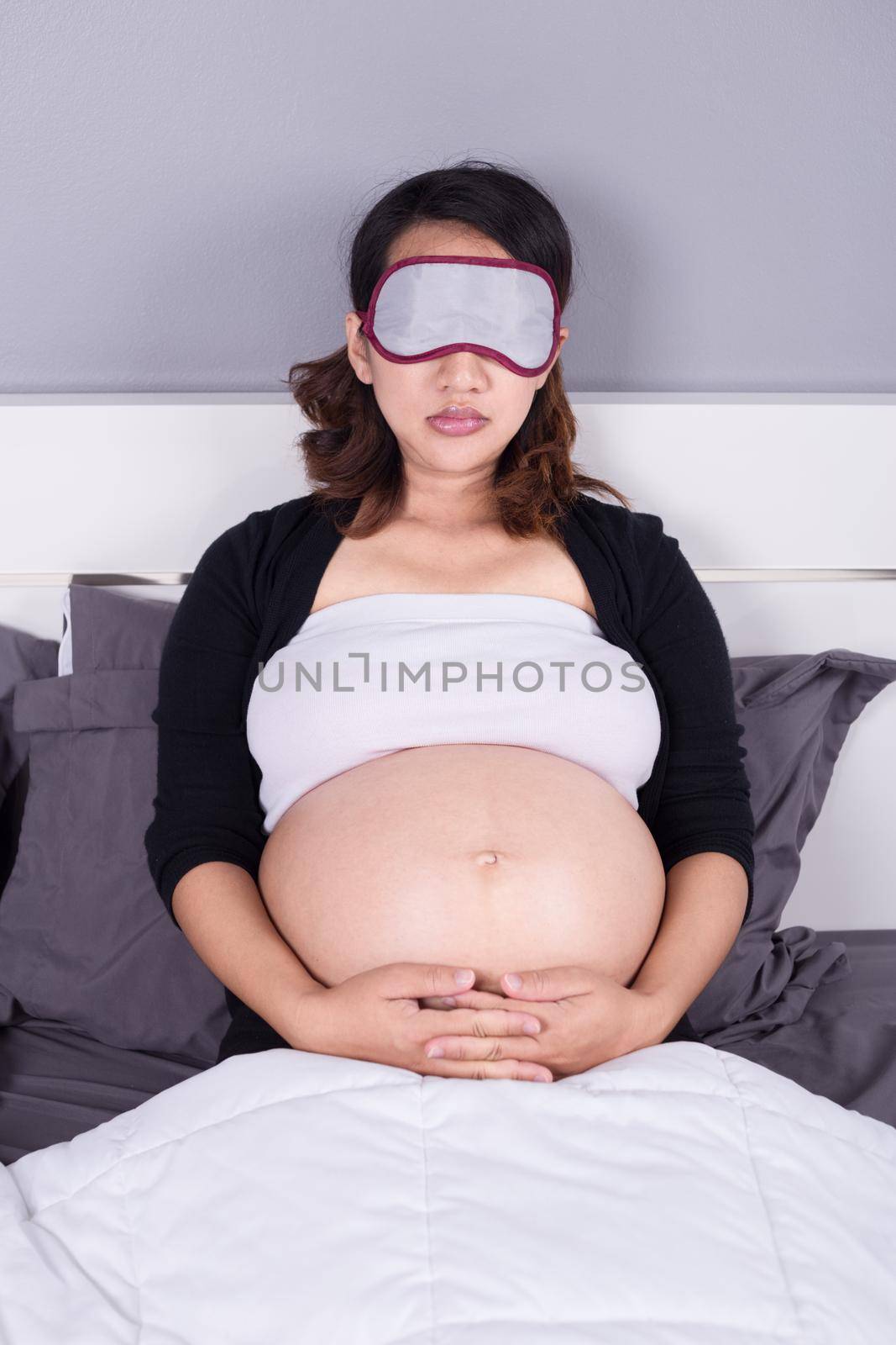 pregnant woman sleeping on bed in the bedroom by geargodz