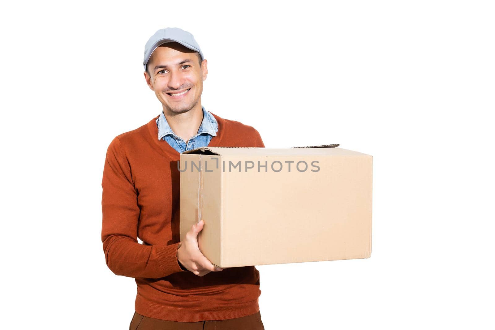 Smiling delivery man giving cardbox on white background.