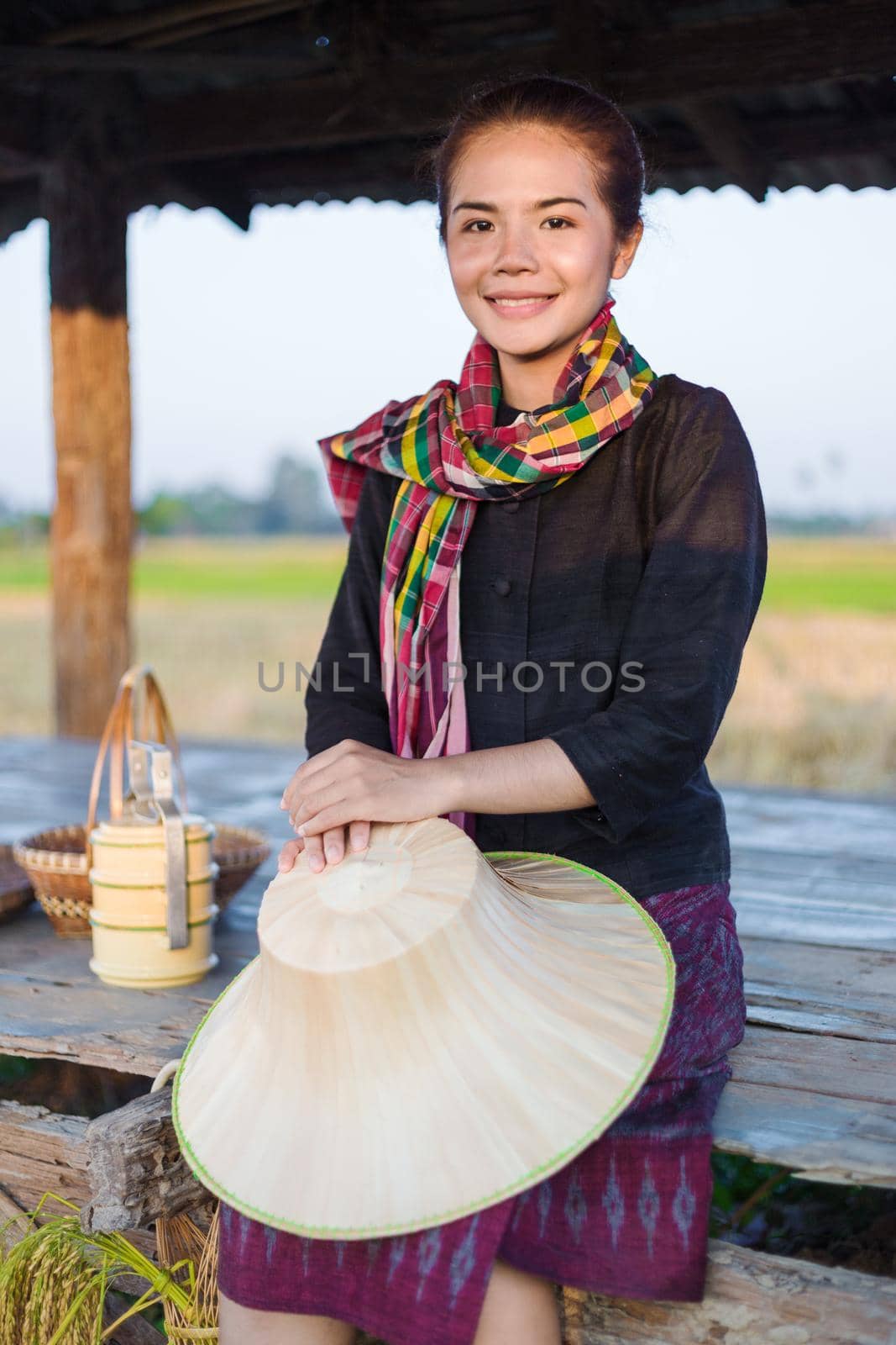 farmer woman sitting in cottage at rice field by geargodz