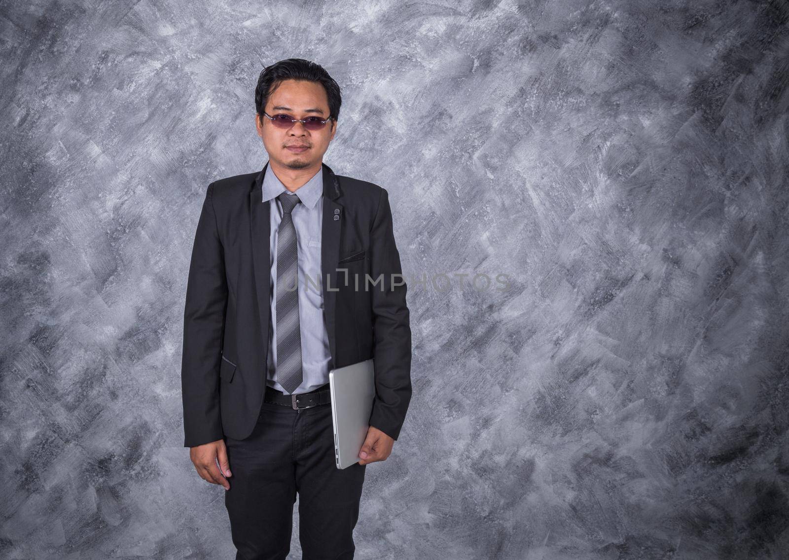 young business man holding laptop by geargodz