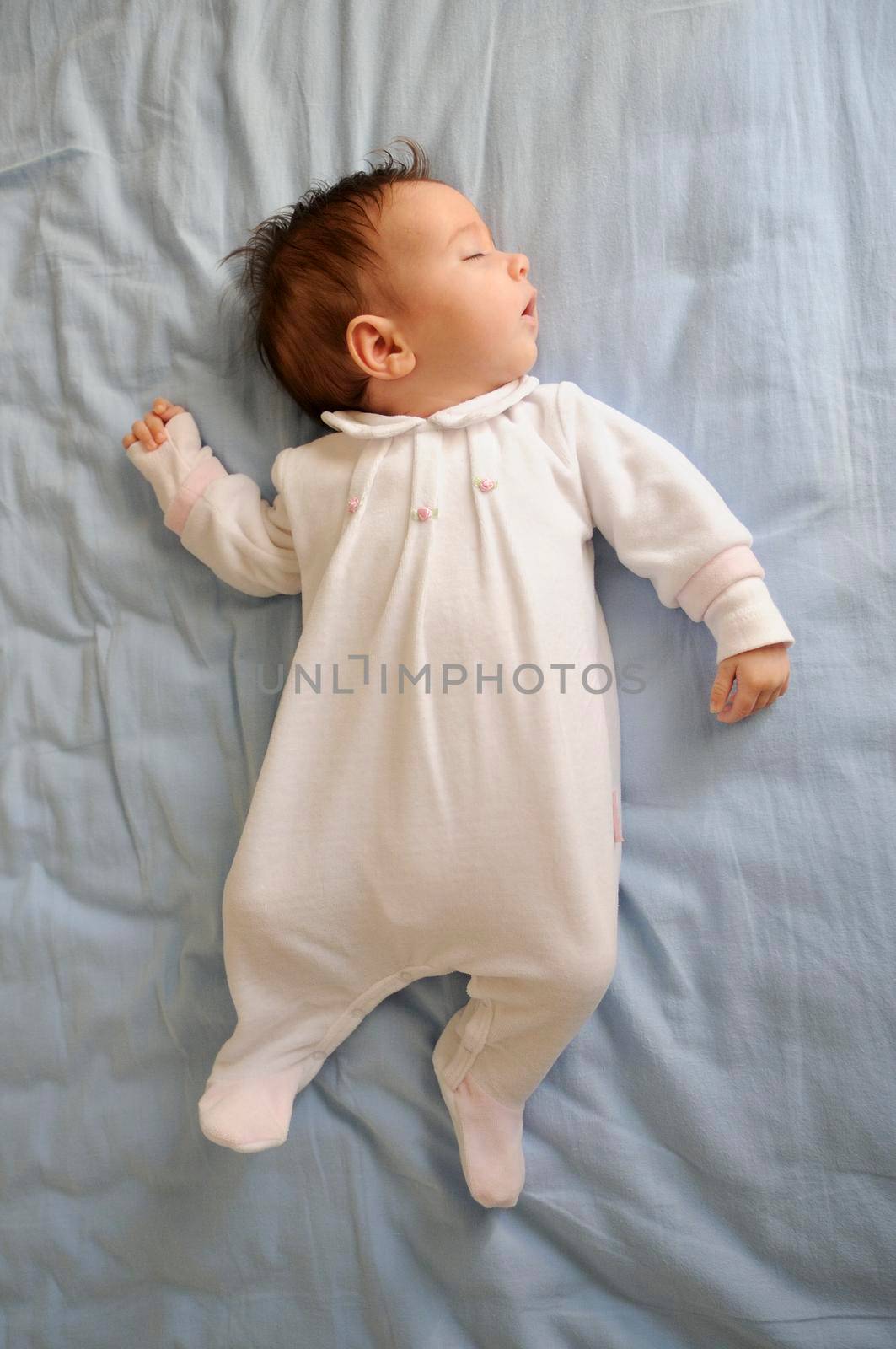 Newborn baby girl sleeping on blue sheets by javiindy
