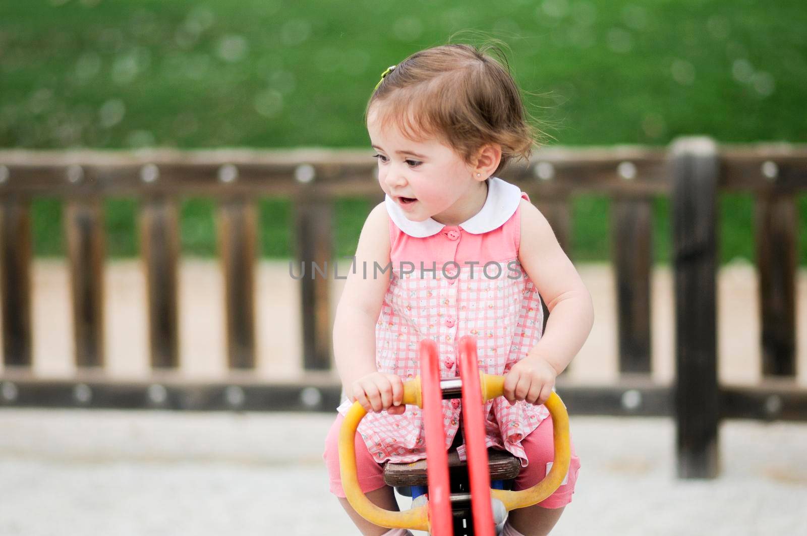 Little girl playing in a urban park by javiindy