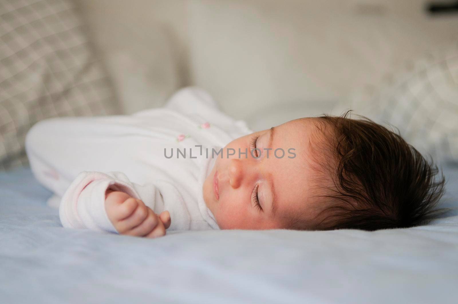 Newborn baby girl sleeping on blue sheets by javiindy