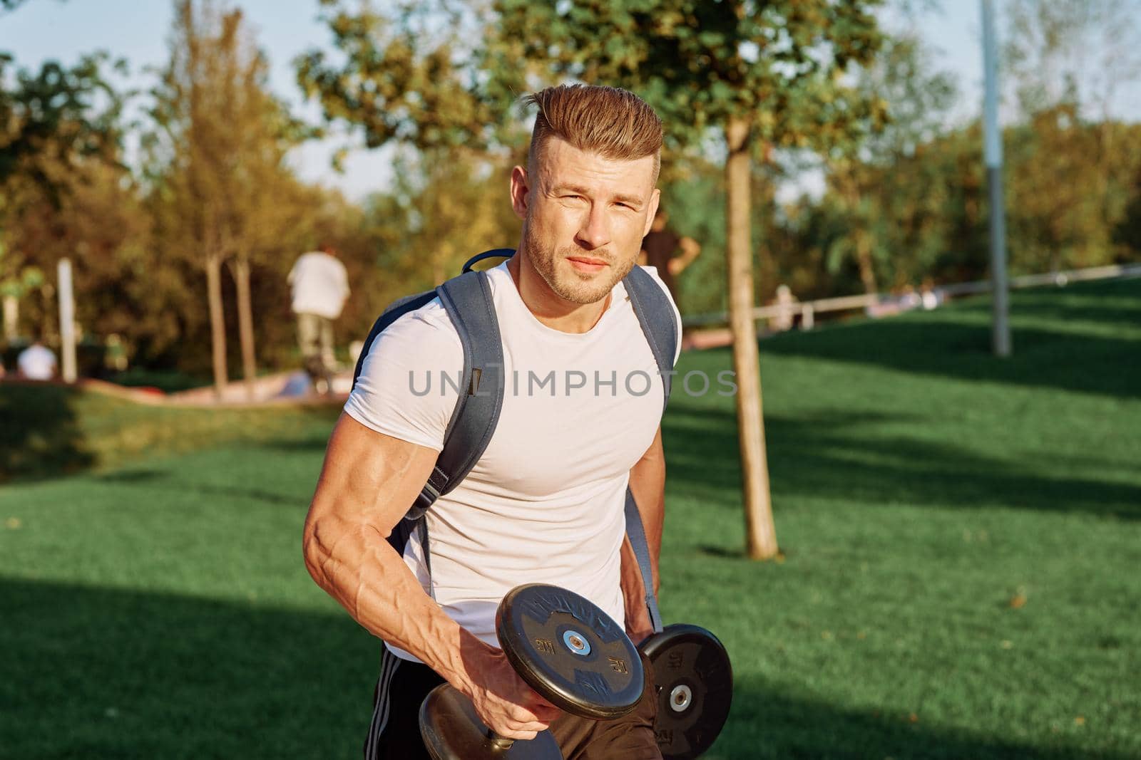 sportive man workout in the park morning motivation. High quality photo