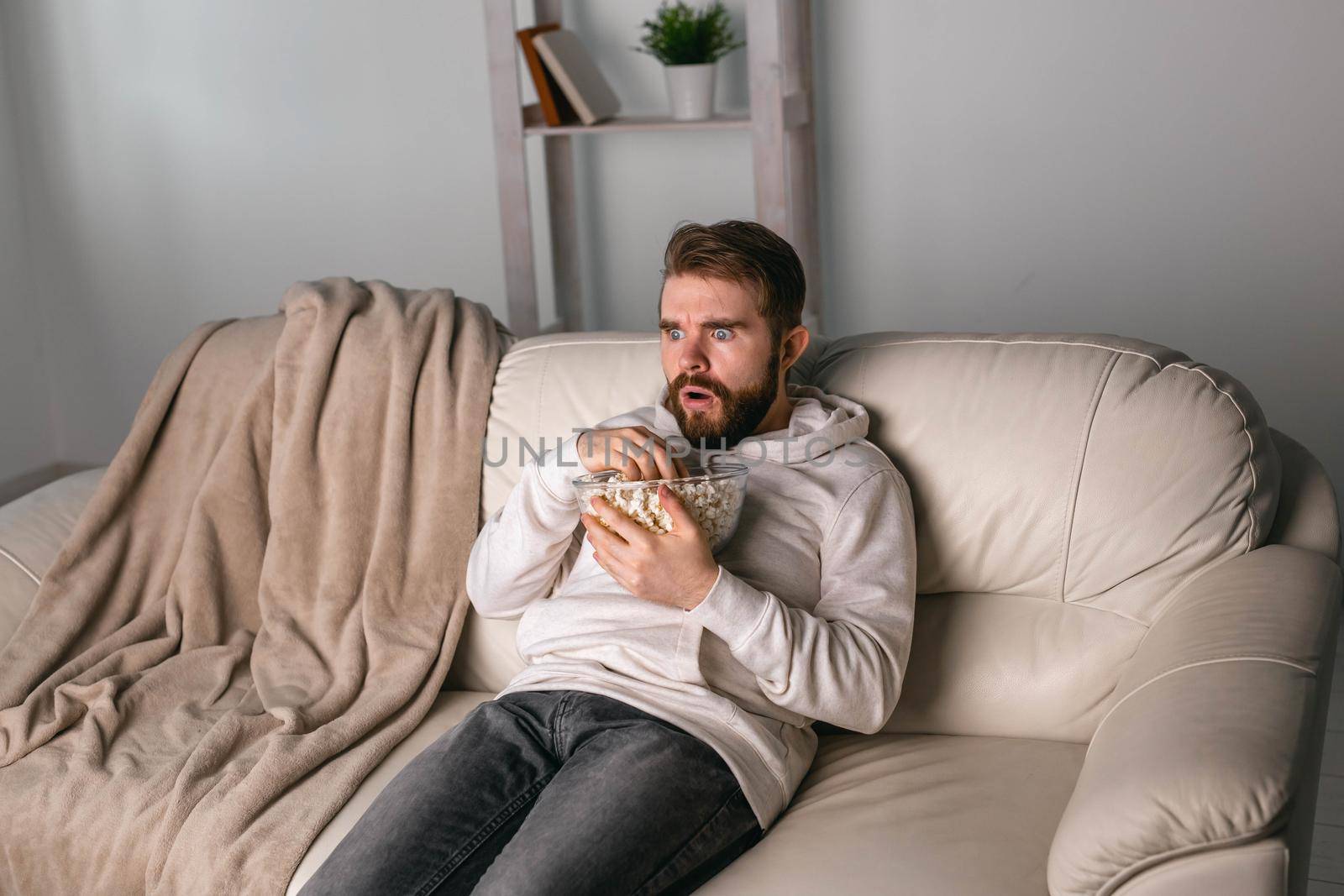 Portrait of guy watching TV series online. Online cinema and video streaming service