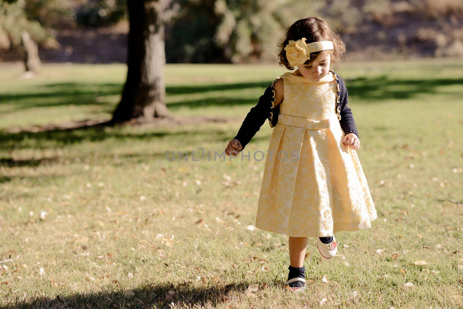 Little girl running and playing in the park by javiindy