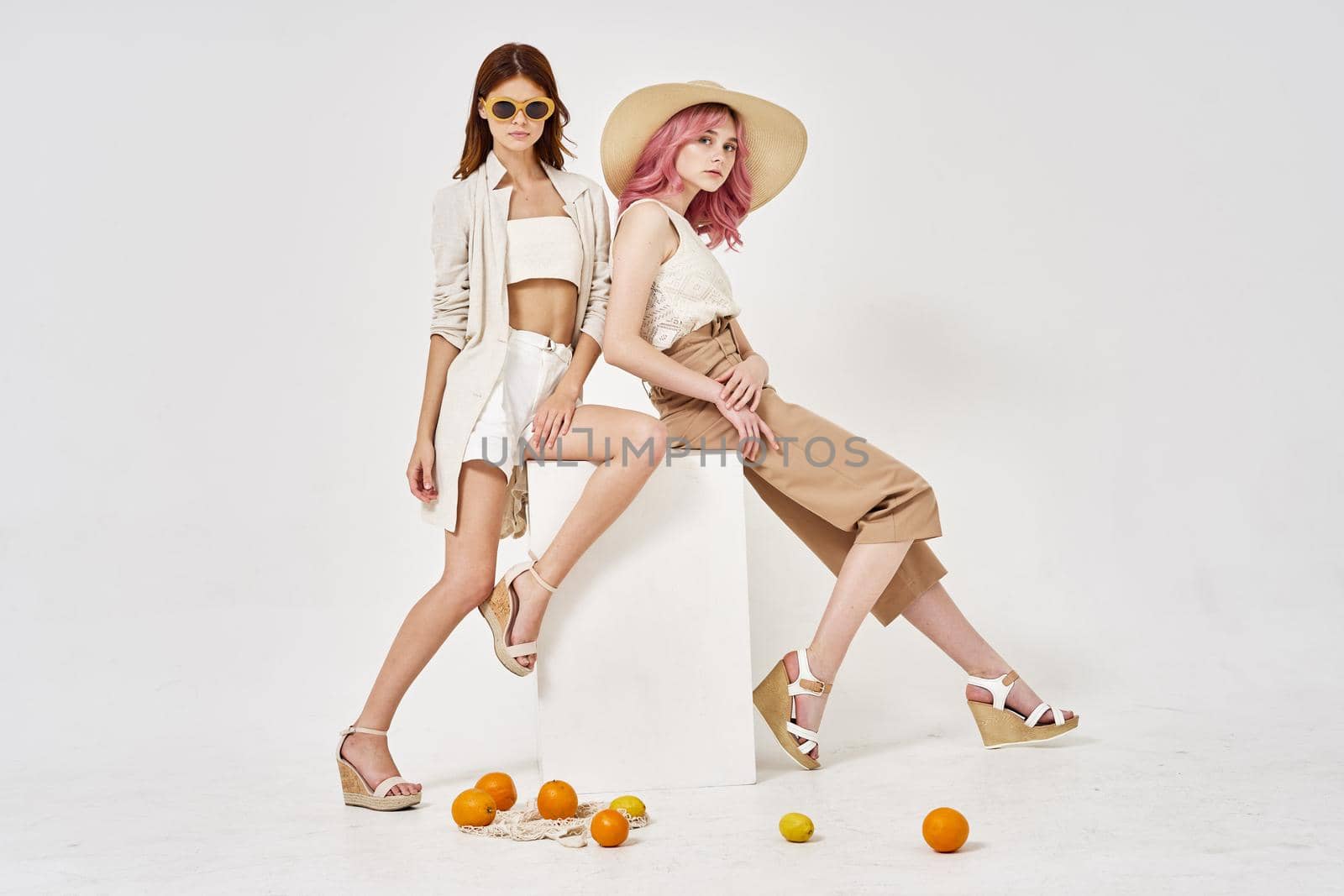 two models posing fashion friendship light background. High quality photo