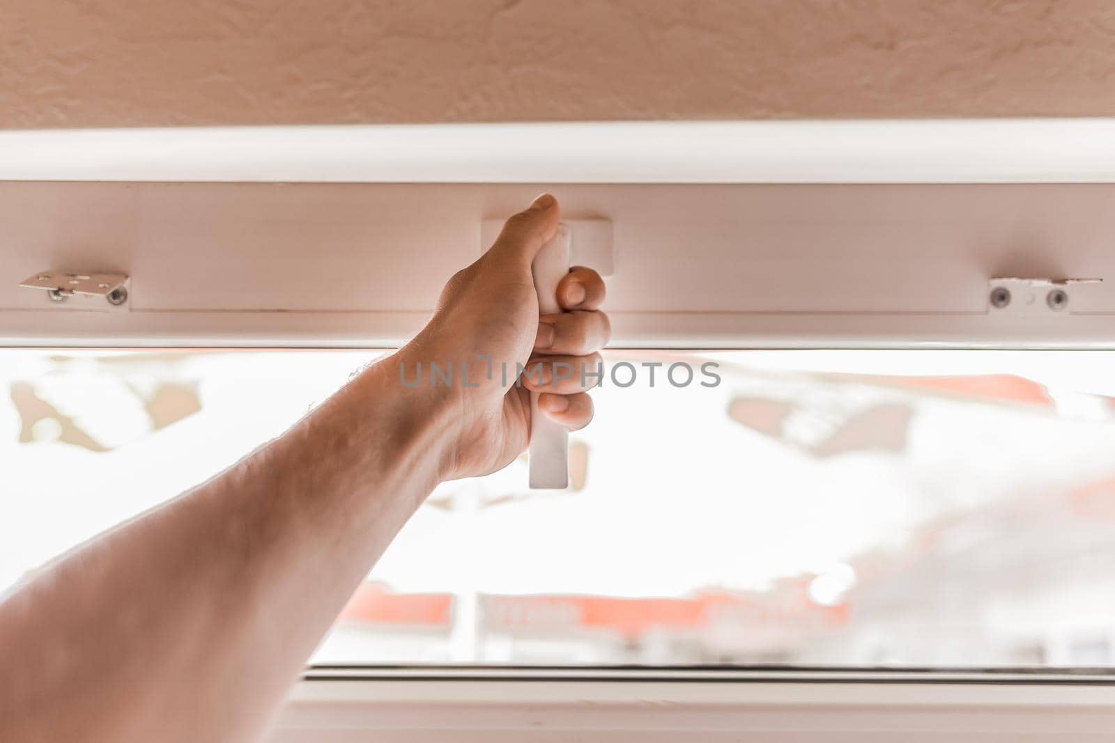 The guy's hand opens a plastic double window for the handle pvc double glazing.