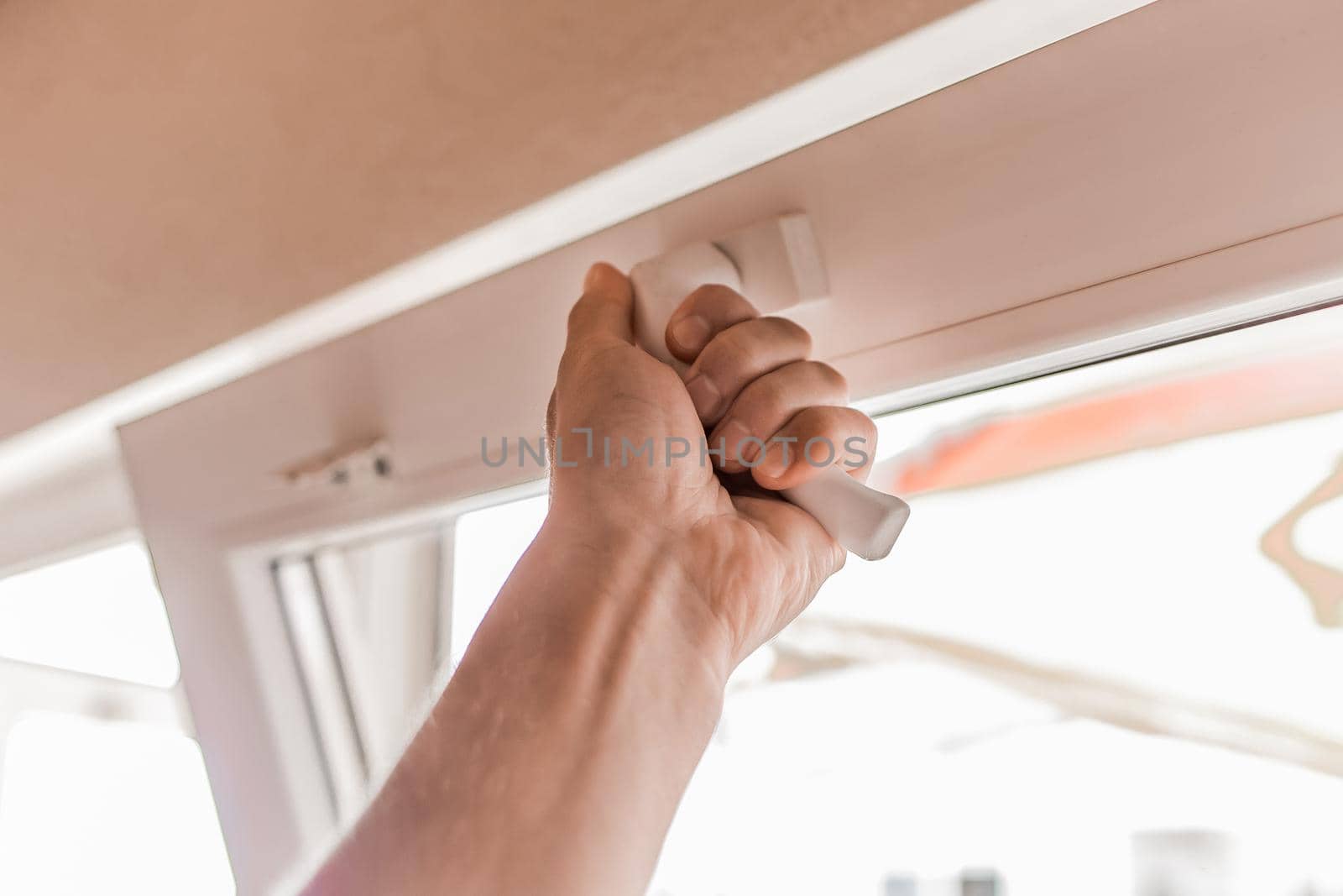 The guy's hand opens a plastic double window for the handle pvc double glazing.