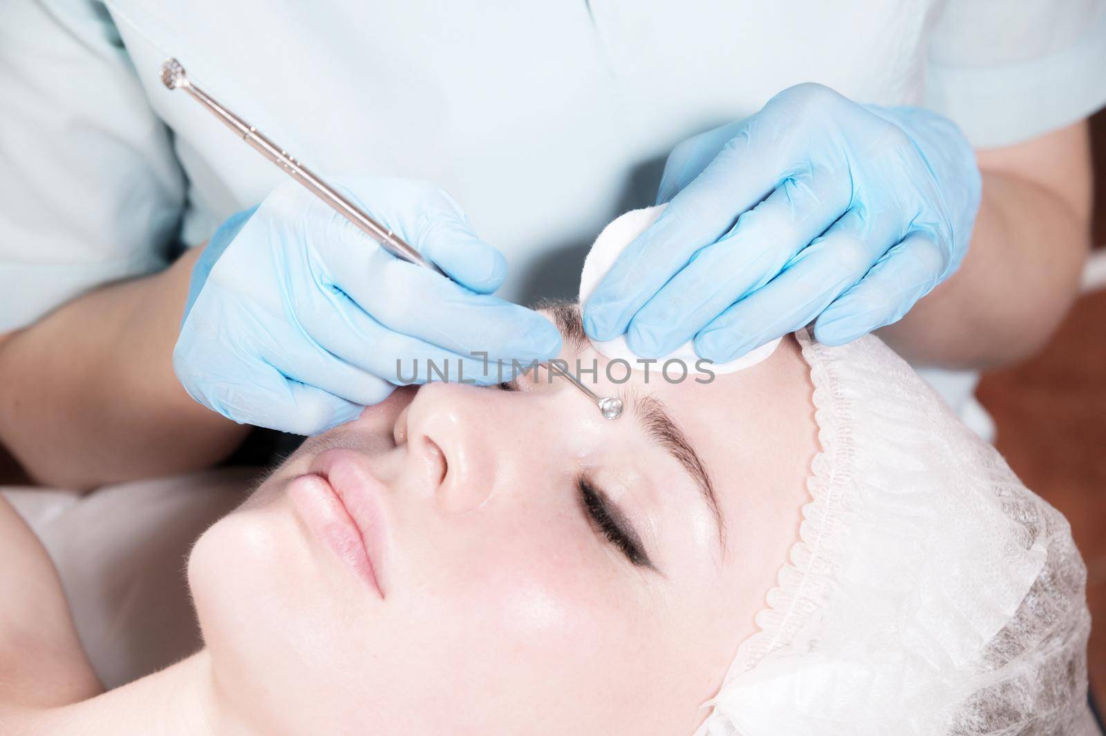Close-up Professional face cleaning. Mechanical face cleansing procedure. Peeling of the skin of the face