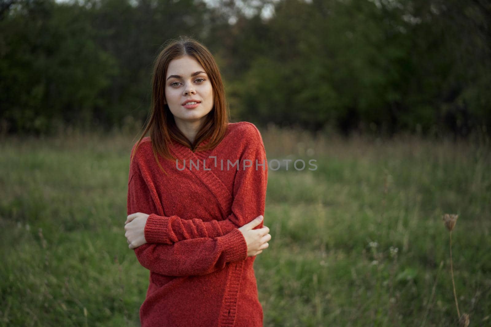 woman in a red sweater outdoors in the field nature rest by Vichizh