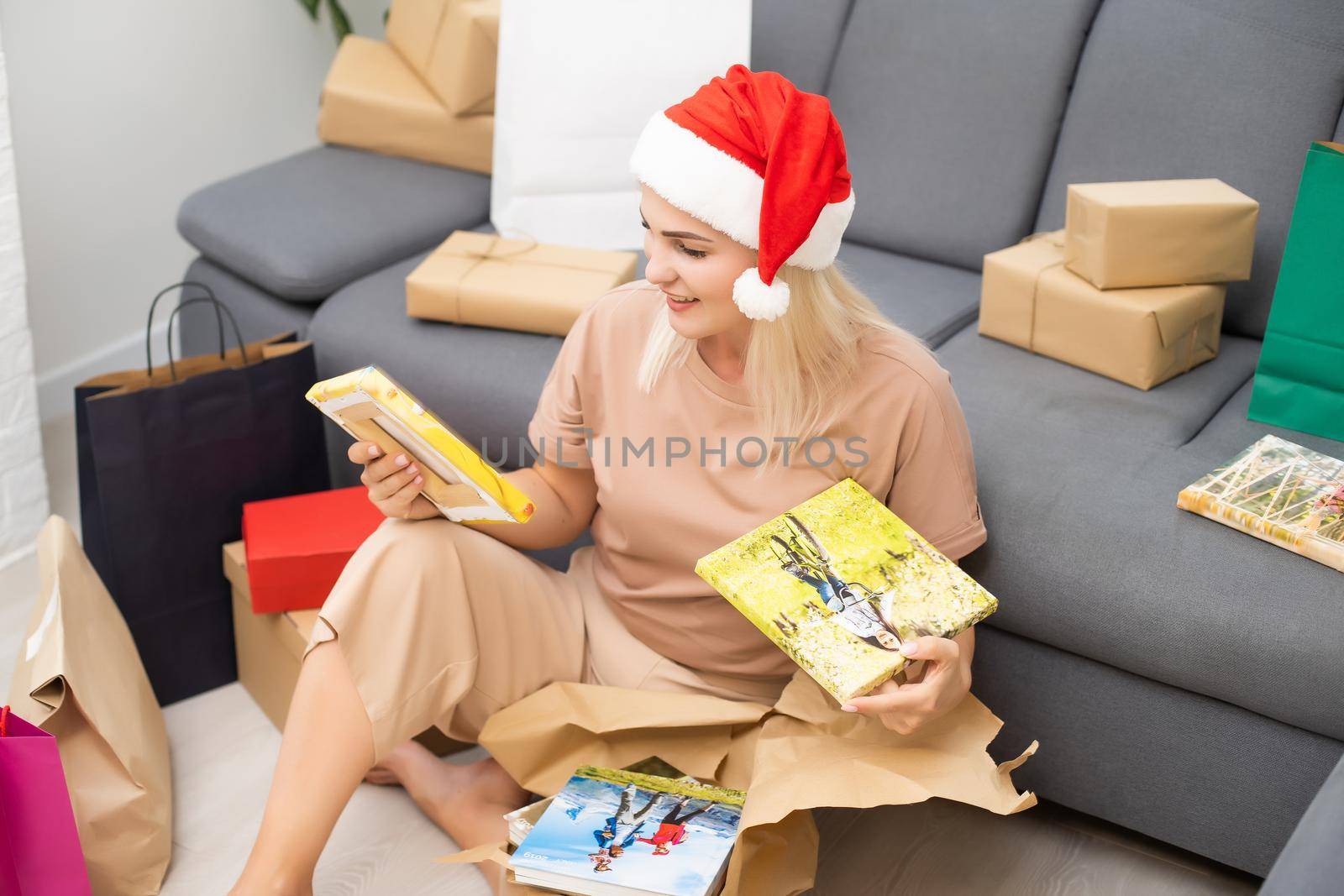 woman holds and unpacks photobook as gift. Present.