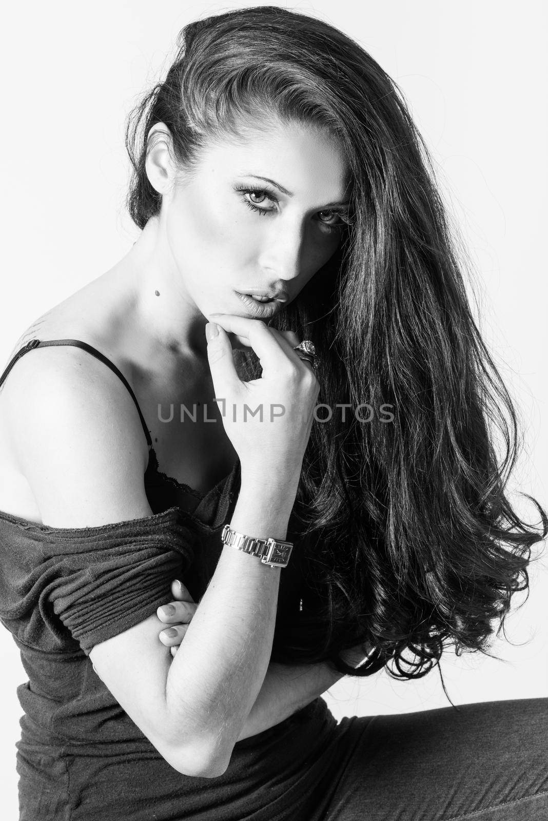 Brunette woman with blue eyes wearing sweater and blue jeans on white background. Studio shoot