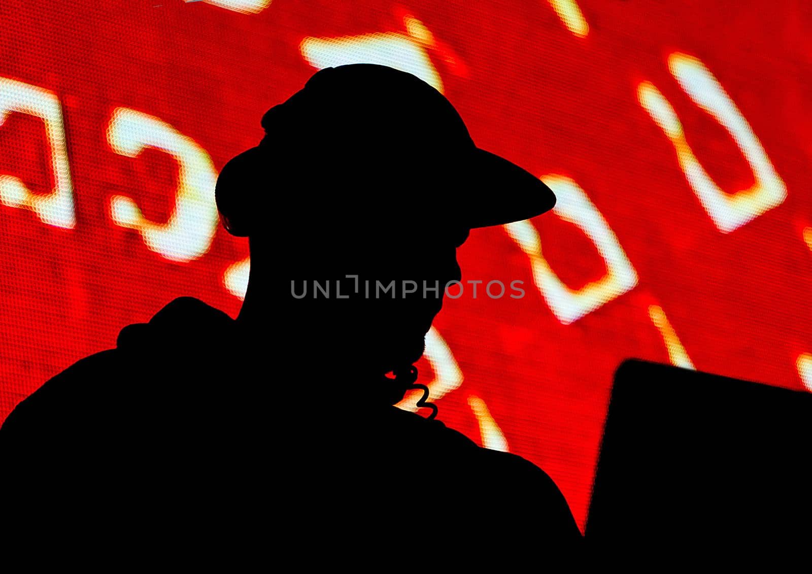 DJ, black silhouette of a man in a cap and headphones on a red background or appeal, propaganda by AYDO8