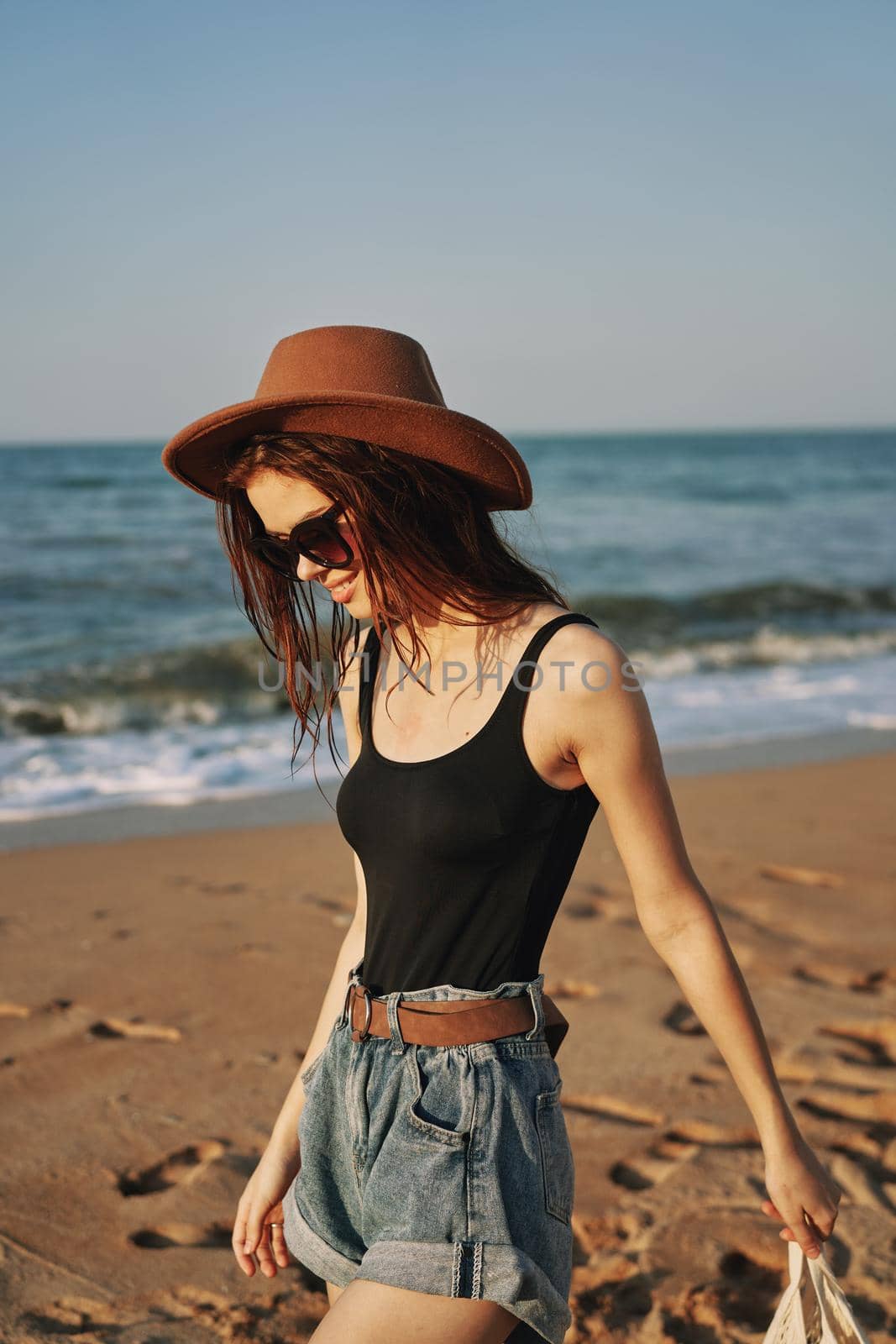 woman in trendy summer clothes by the ocean vacation sun. High quality photo