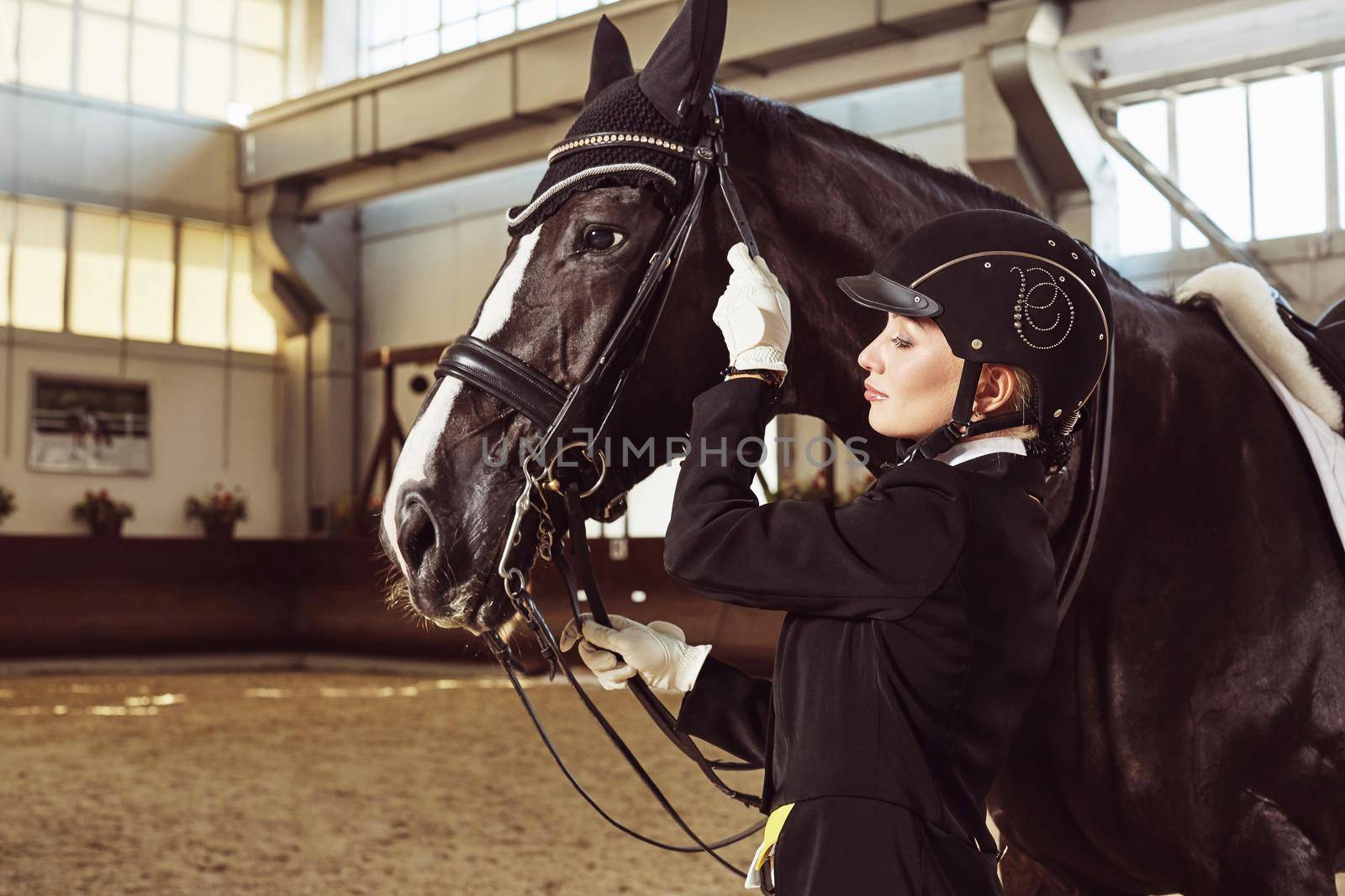 woman jockey with his horse in uniform for Dressage