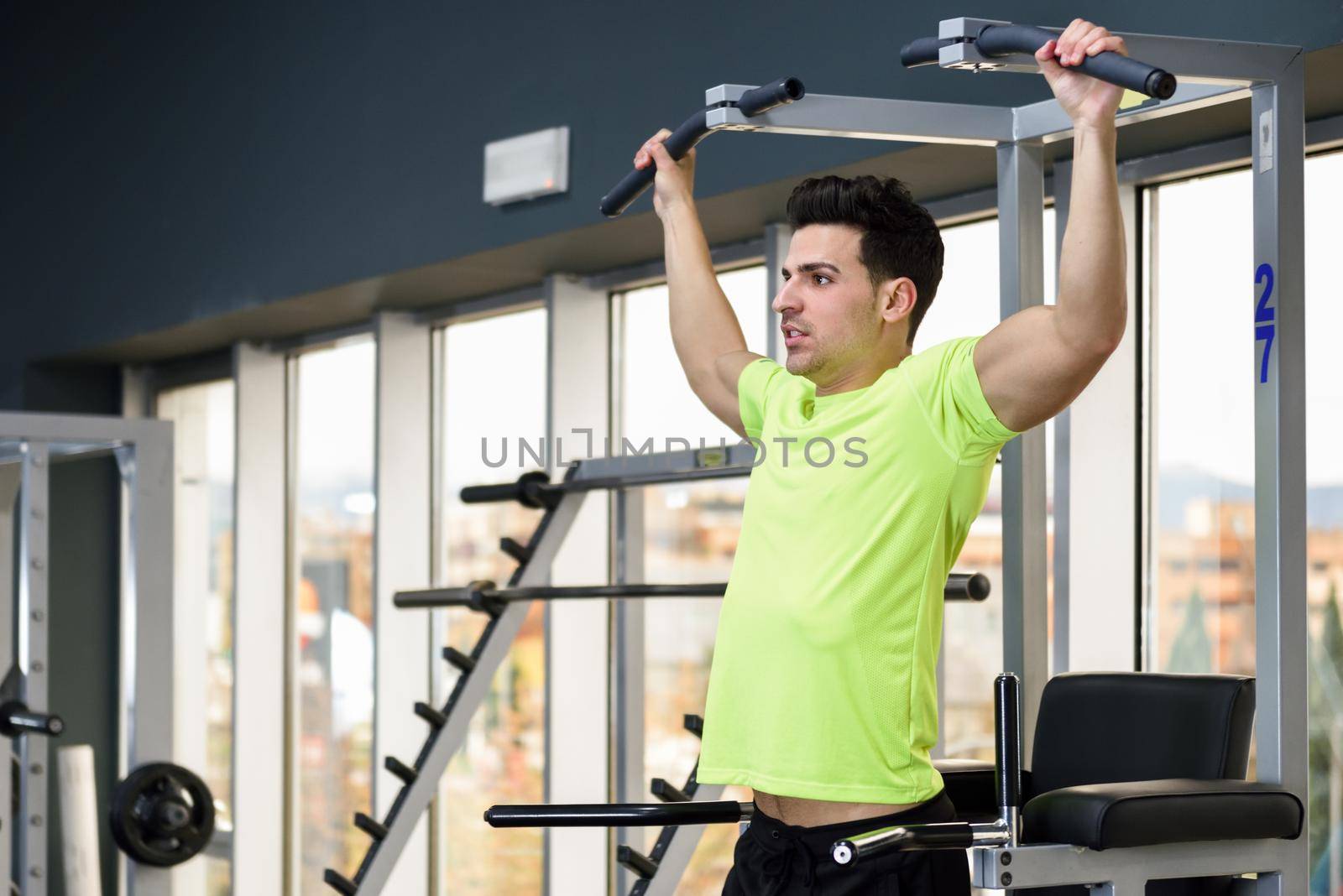 Young fit man wearing sportswear training at the gym by javiindy