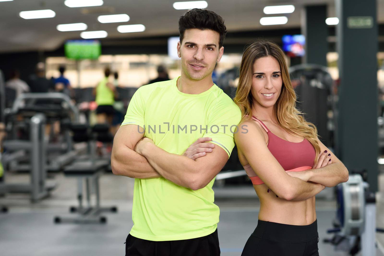 Man and woman personal trainers in the gym. by javiindy