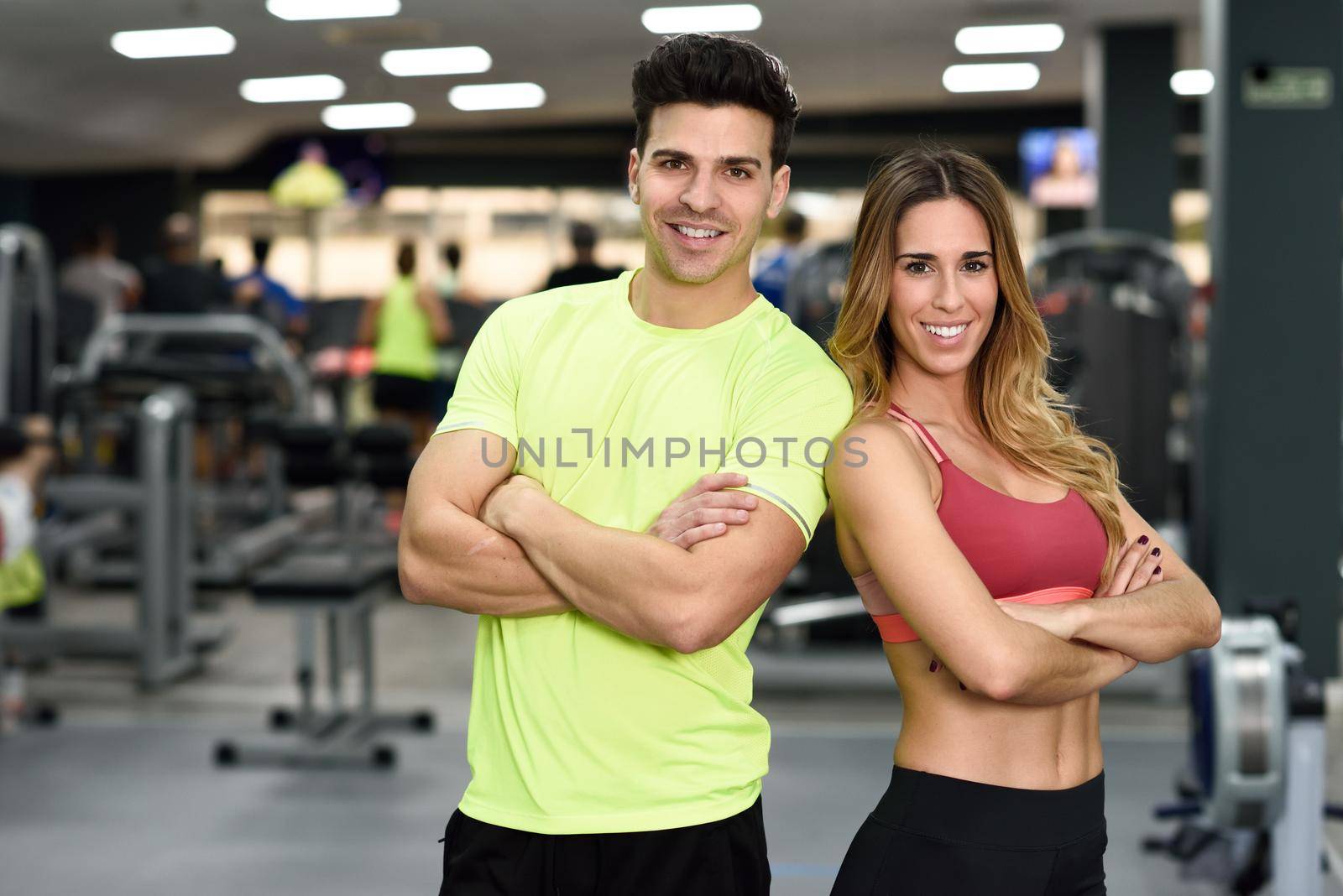 Man and woman personal trainers in the gym. by javiindy