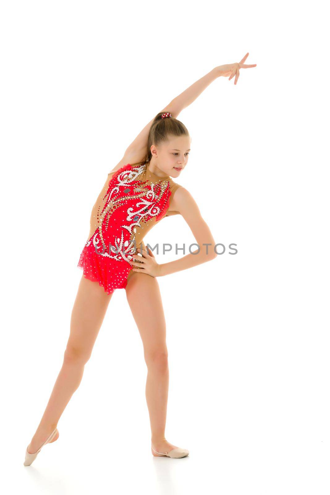 Cute little girl gymnast getting ready to perform a difficult exercise. by kolesnikov_studio
