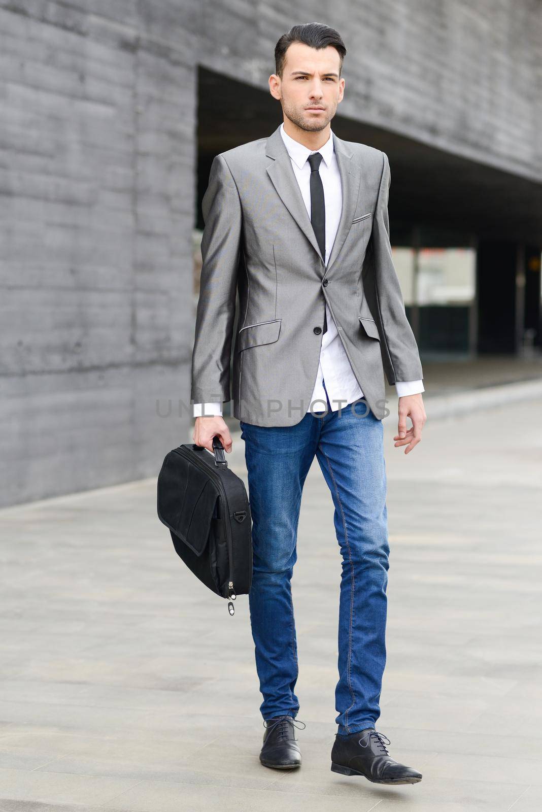 Portrait of a young businessman near a office building