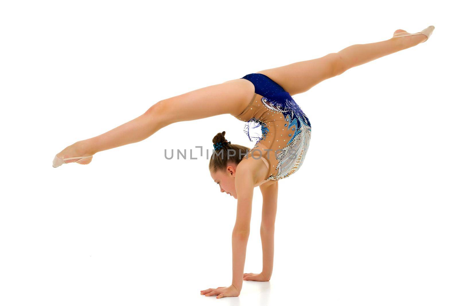 Beautiful girl gymnast performs a handstand. by kolesnikov_studio