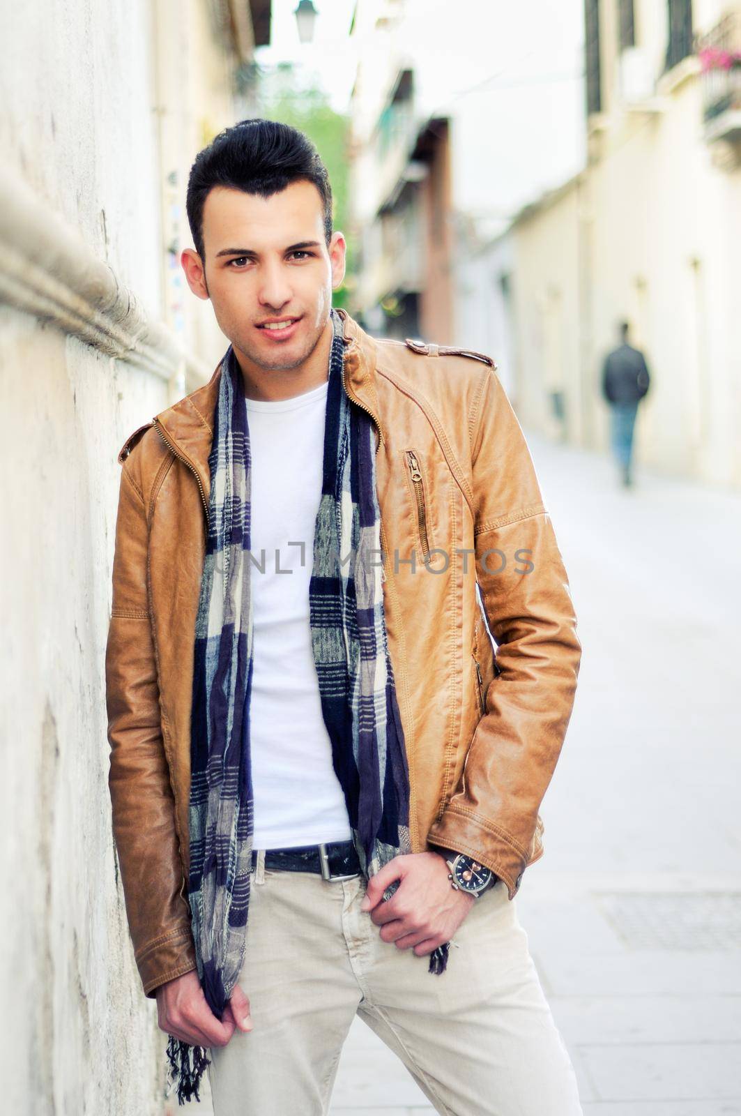 Portrait of a young handsome man, model of fashion, with toupee in urban background