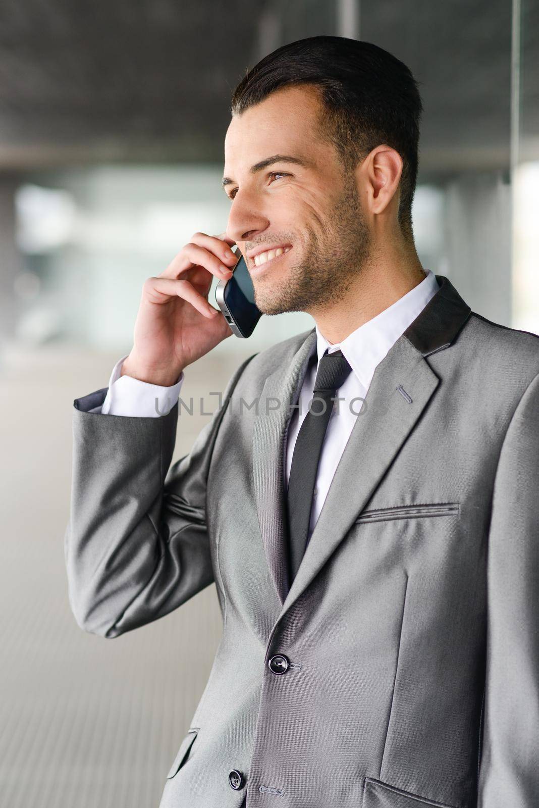 Portrait of an attractive young businessman on the phone in an office building