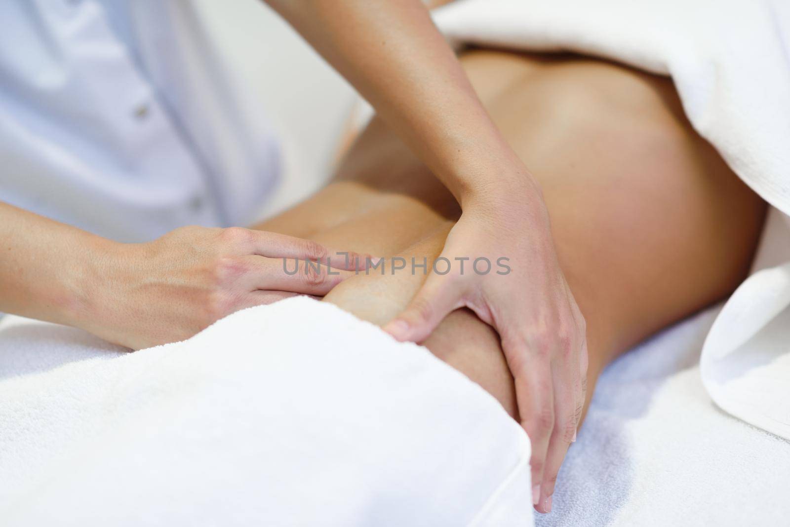 Woman receiving a belly massage at spa salon by javiindy