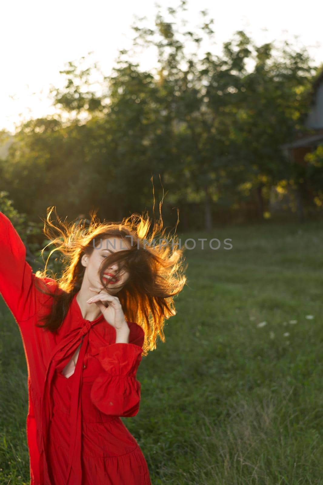 woman in red dress posing nature sun fun. High quality photo