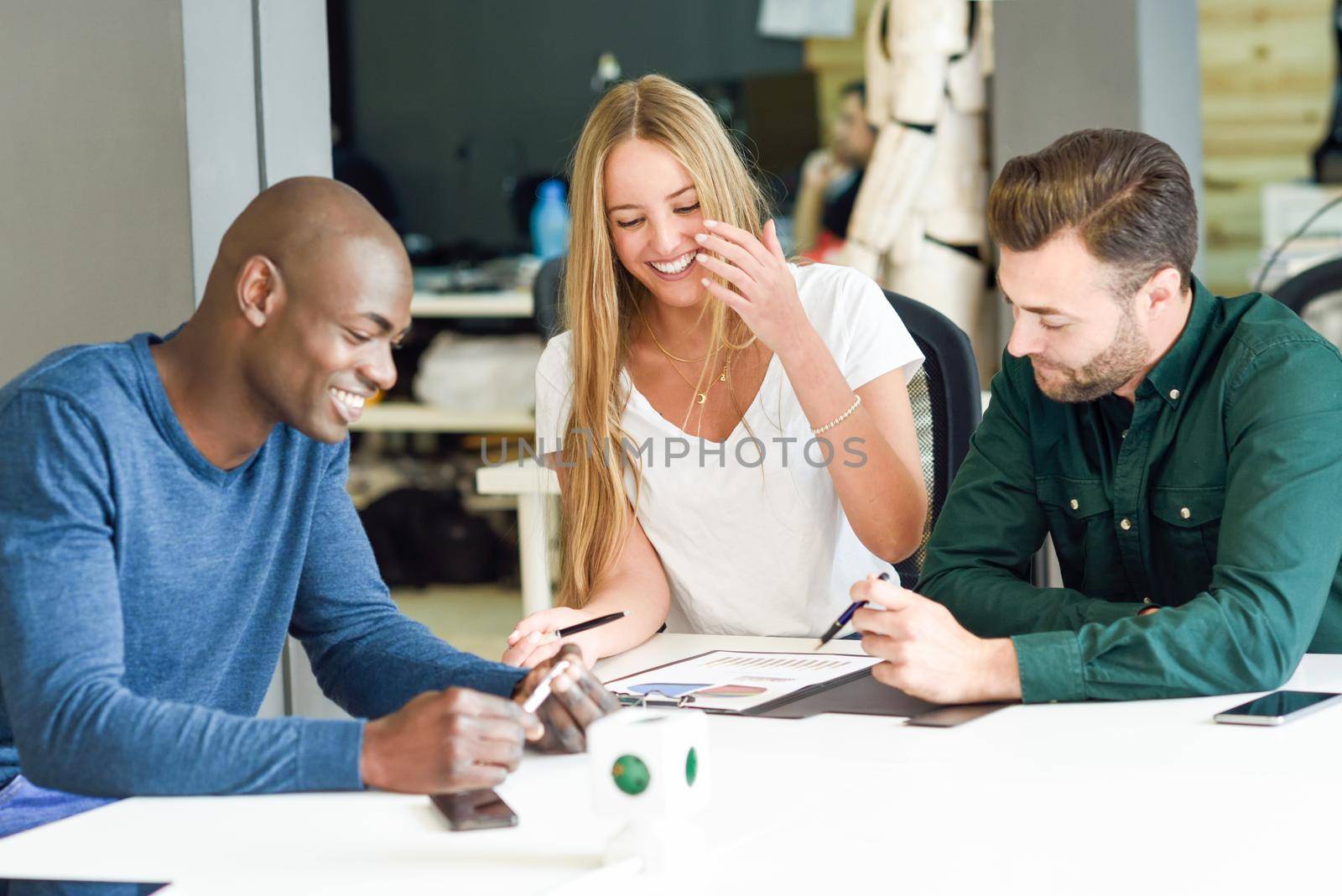 Multi-ethnic group of three young people studying and smiling together by javiindy