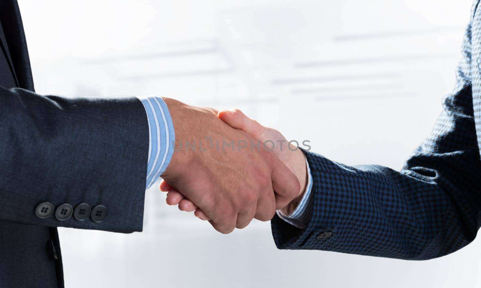 A close-up of a handshake. Making a deal between two businessmen