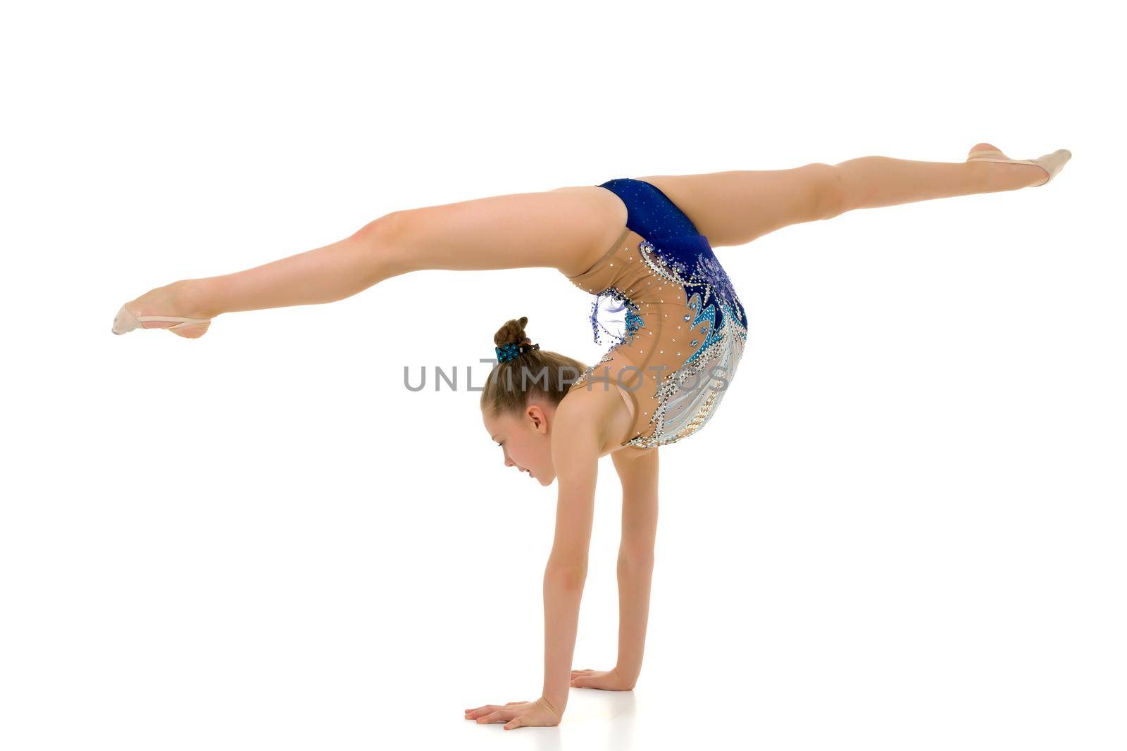 A slender girl gymnast, in a beautiful gymnastic leotard for competitions, performs a handstand. Concept for kids sport competition. isolated on a white background.