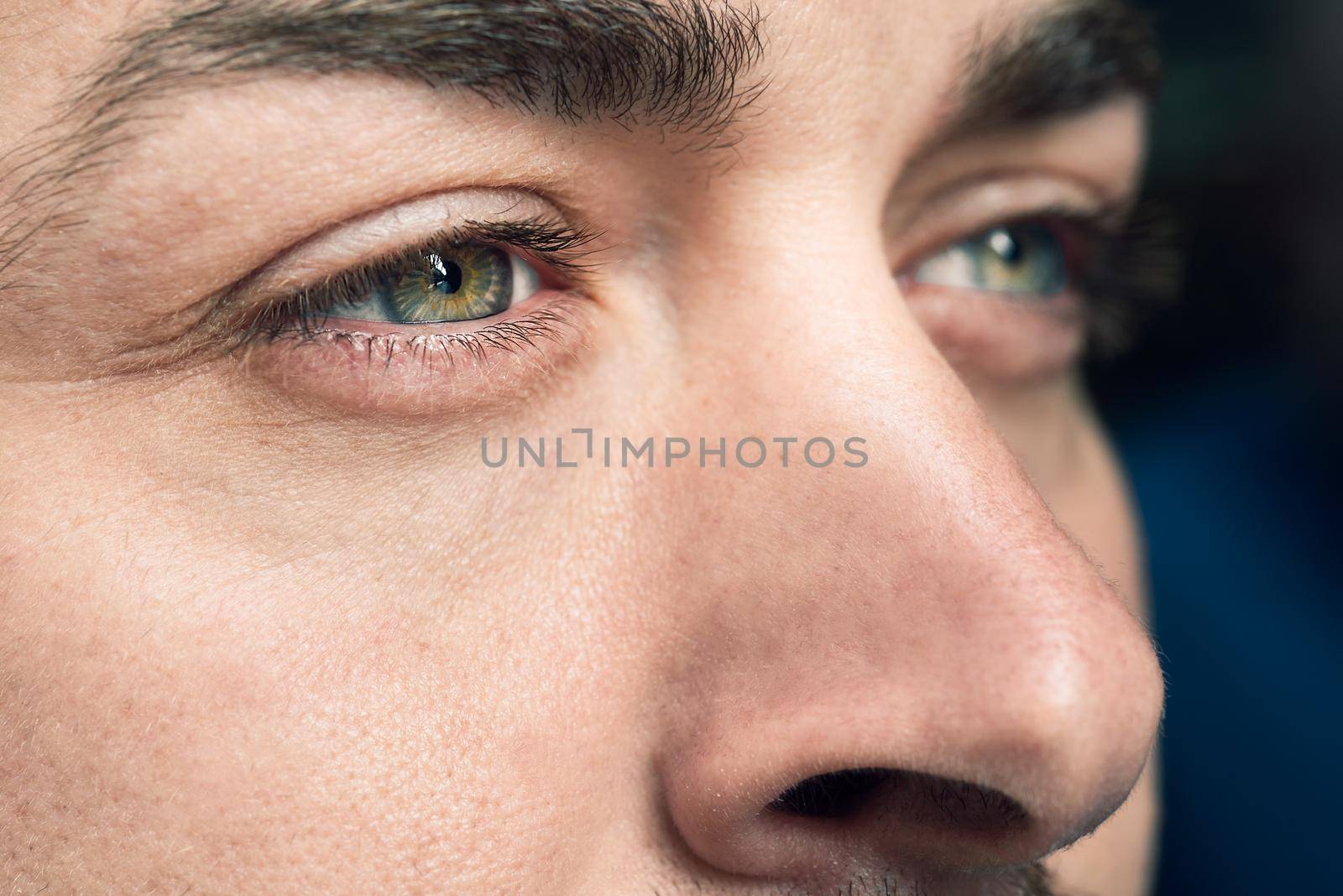 Close-up shot of man's eye. Man with blue eyes.