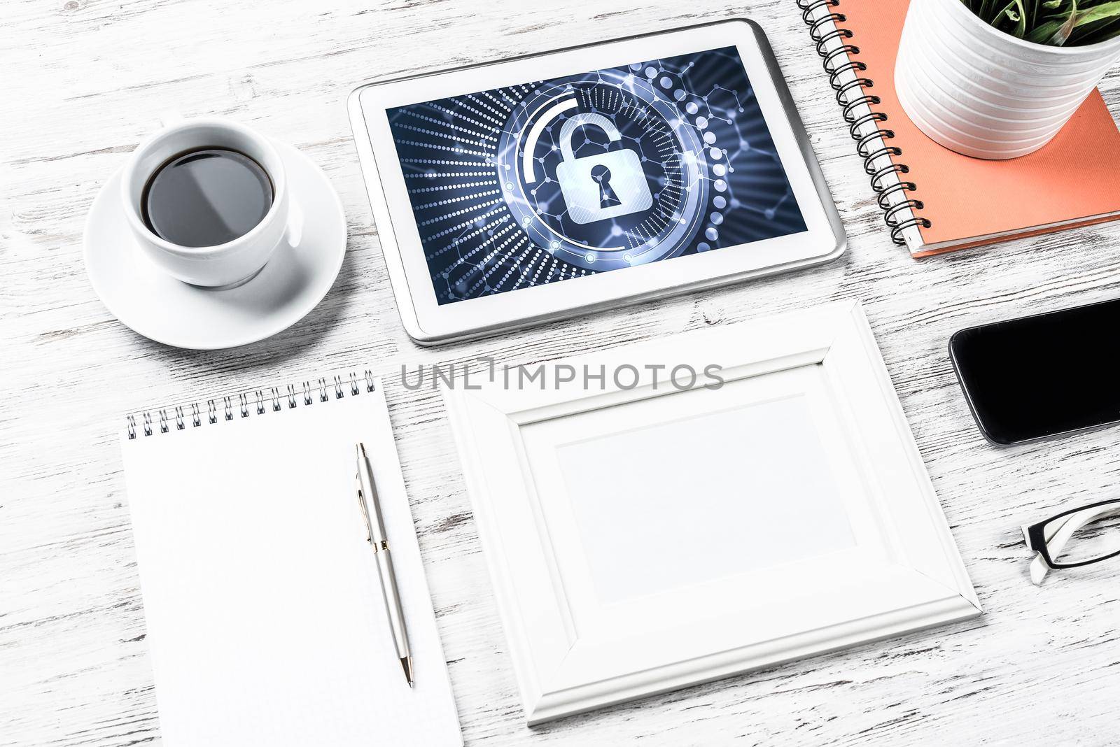 Business workplace with office stuff and tablet with padlock icons on screen