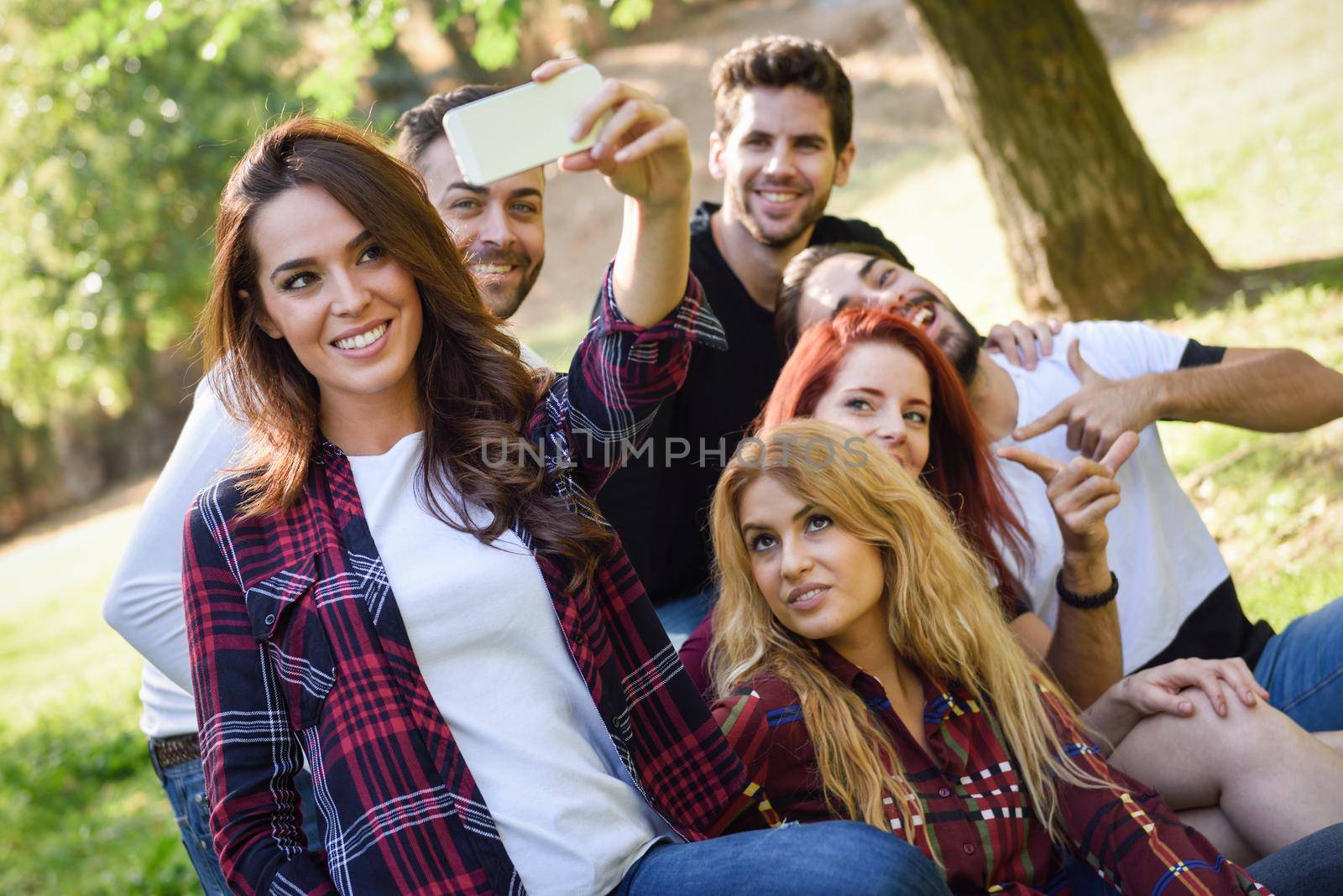 Group of friends taking selfie in urban background by javiindy